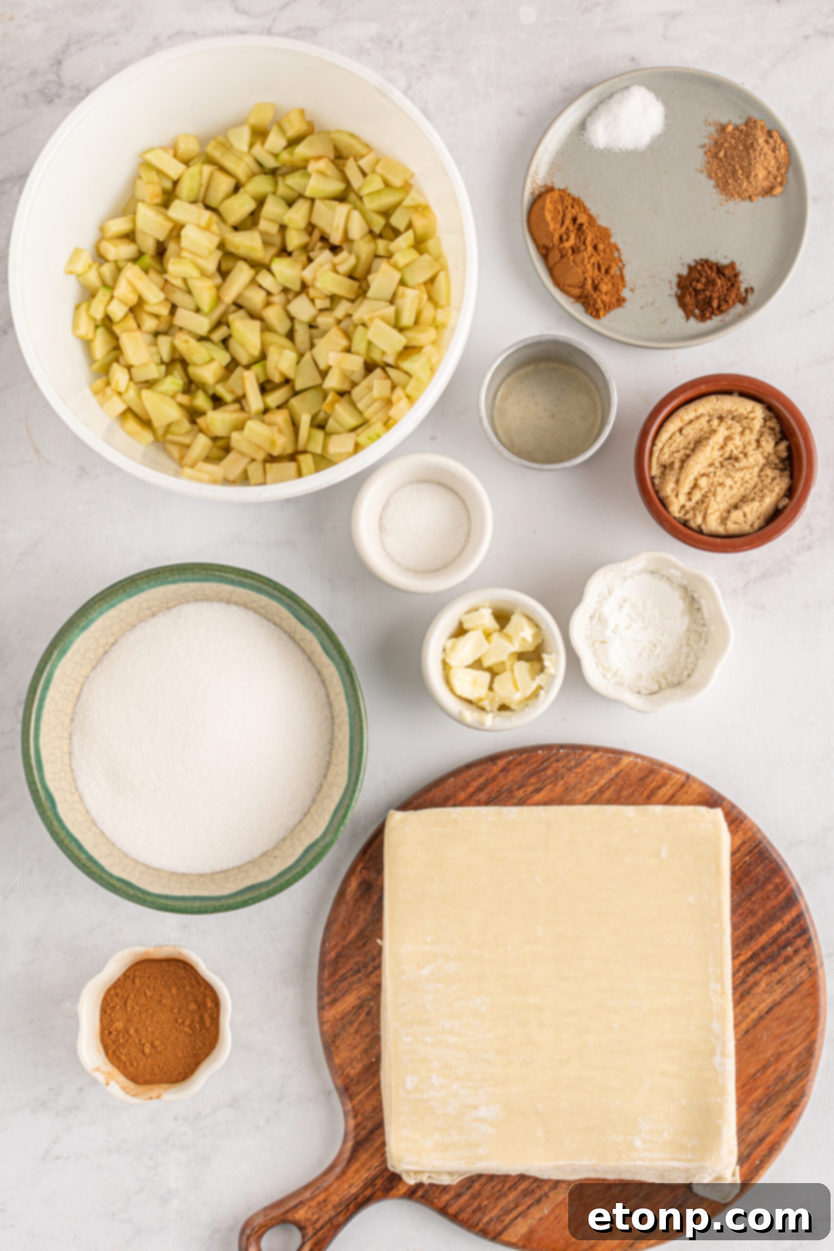 An inviting overhead photograph displaying all the essential ingredients neatly laid out on a clean surface, ready for preparing the Apple Pie Egg Rolls.