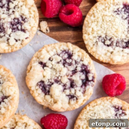 Overhead shot of the cookies on wax paper with fresh raspberries.