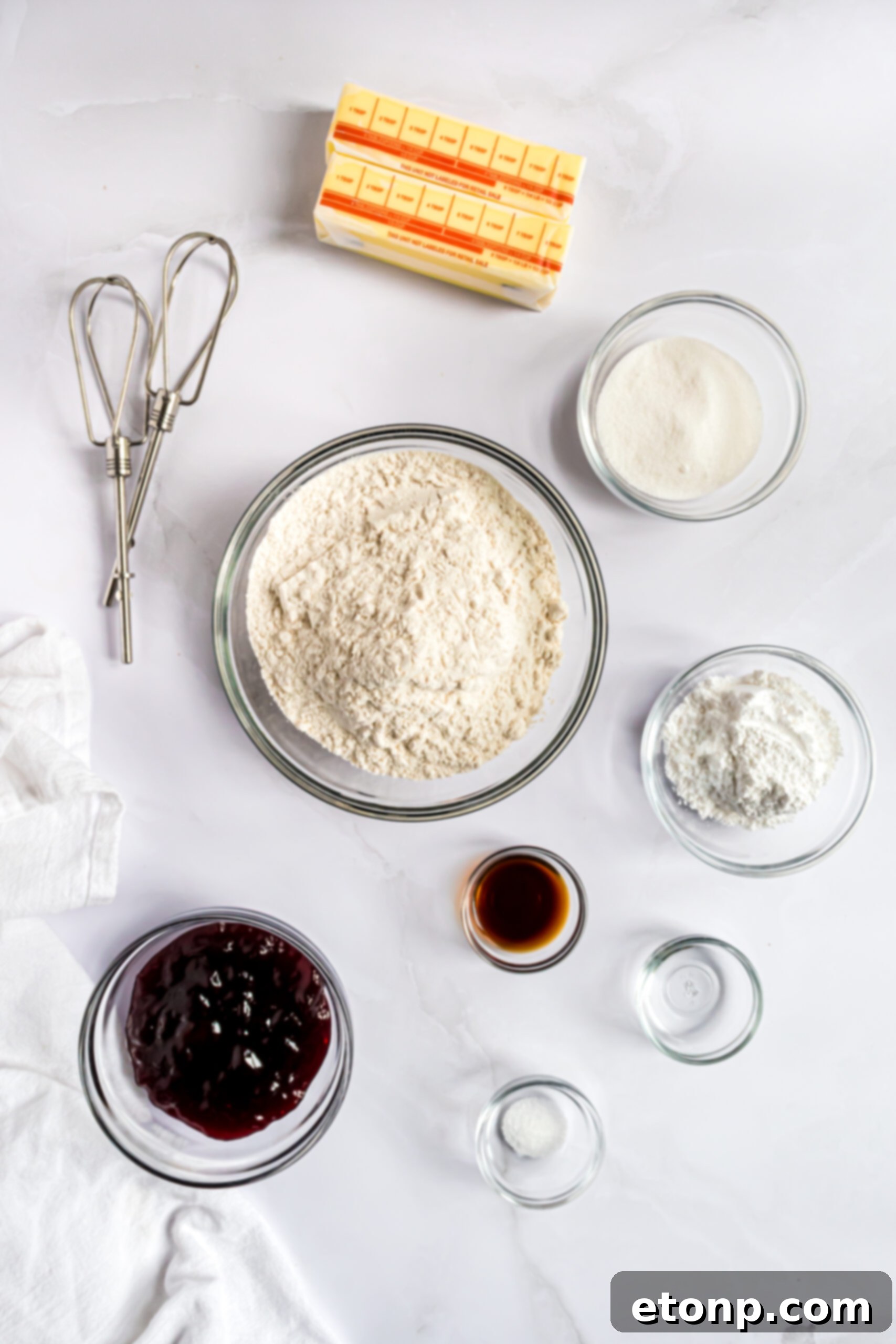 Overhead shot of the ingredients for raspberry cookies laid out on a surface.