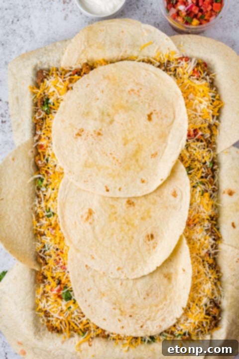 Overhead view of sheet pan tacos with toppings.