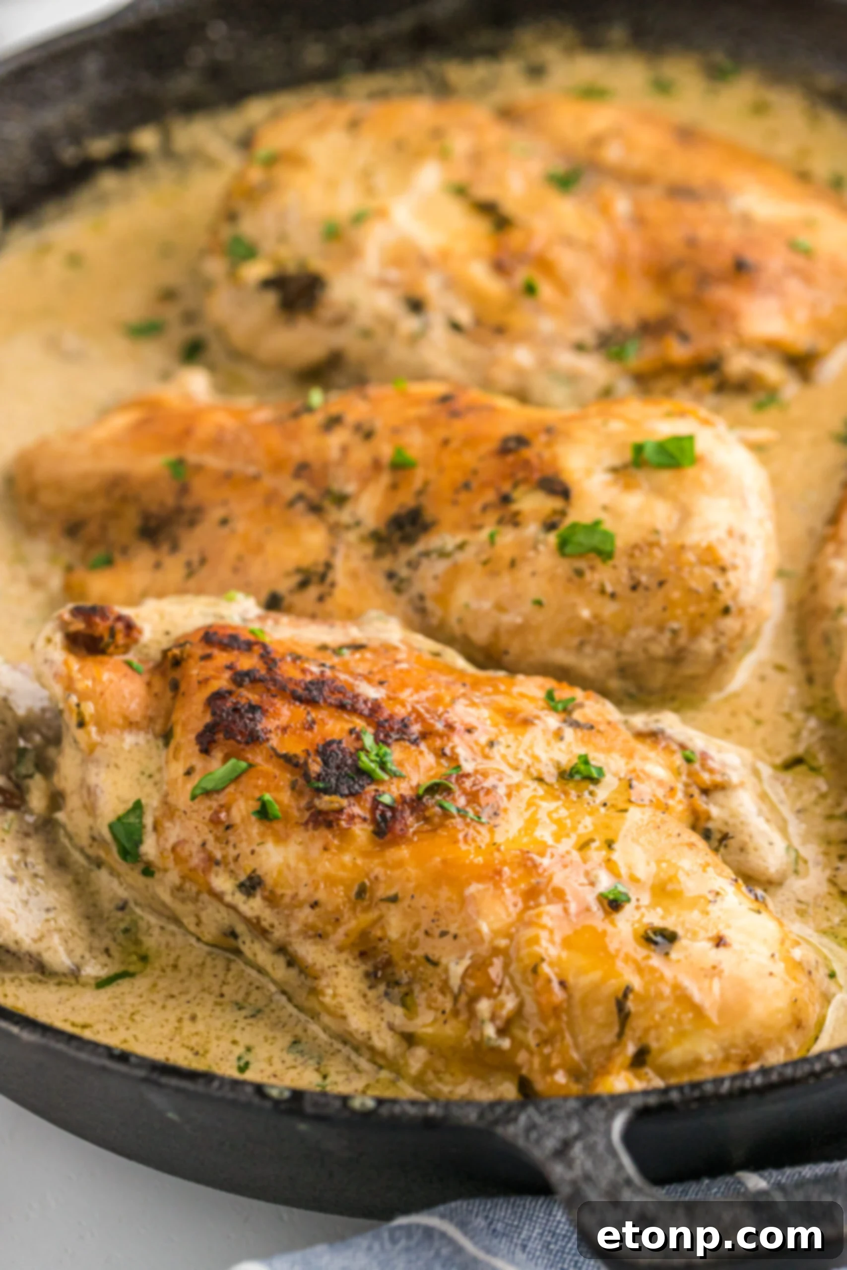 Cheesy Garlic Butter Mushroom Stuffed Chicken in a cast iron skillet. 