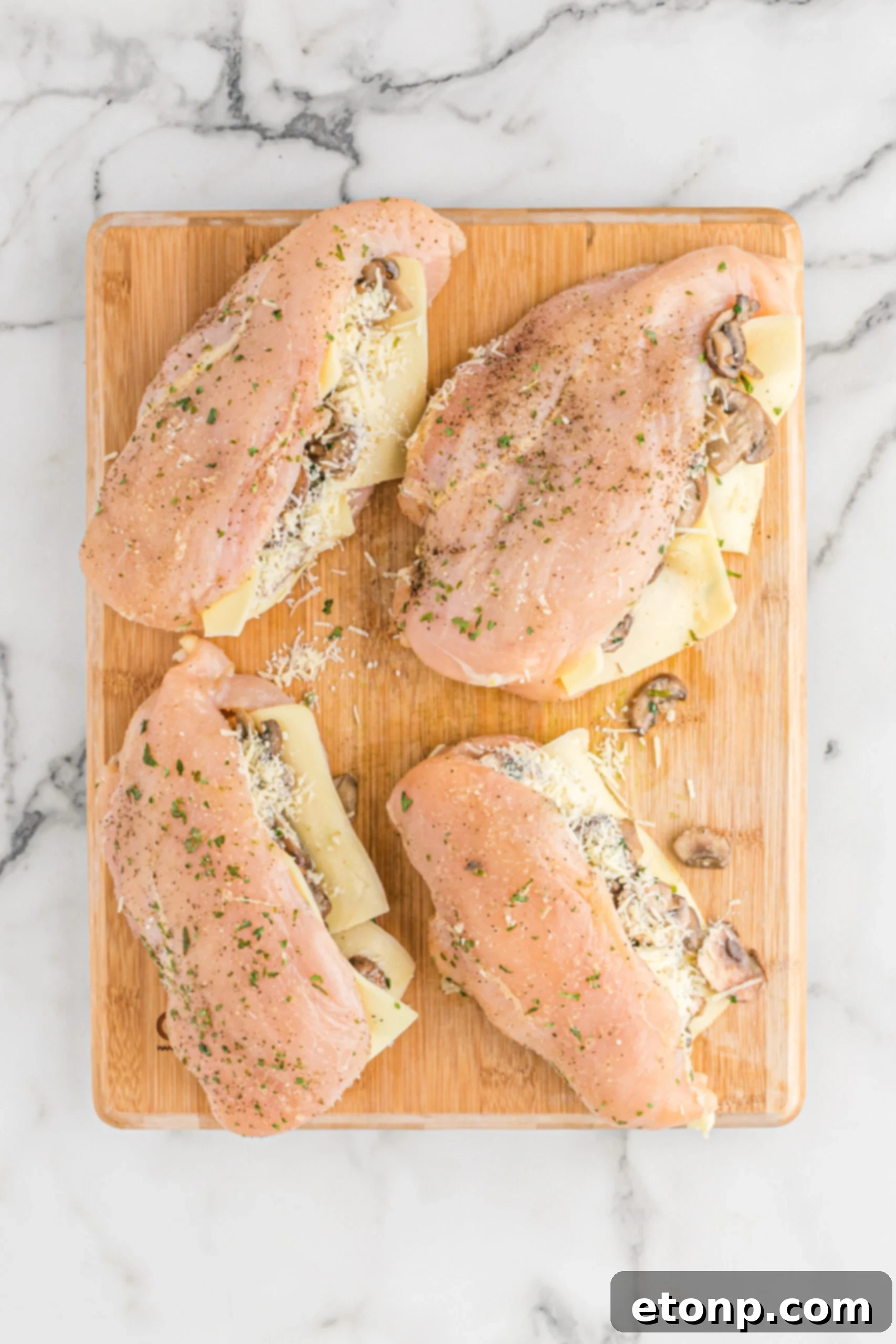 Overhead view of the raw chicken stuffed with ingredients. 