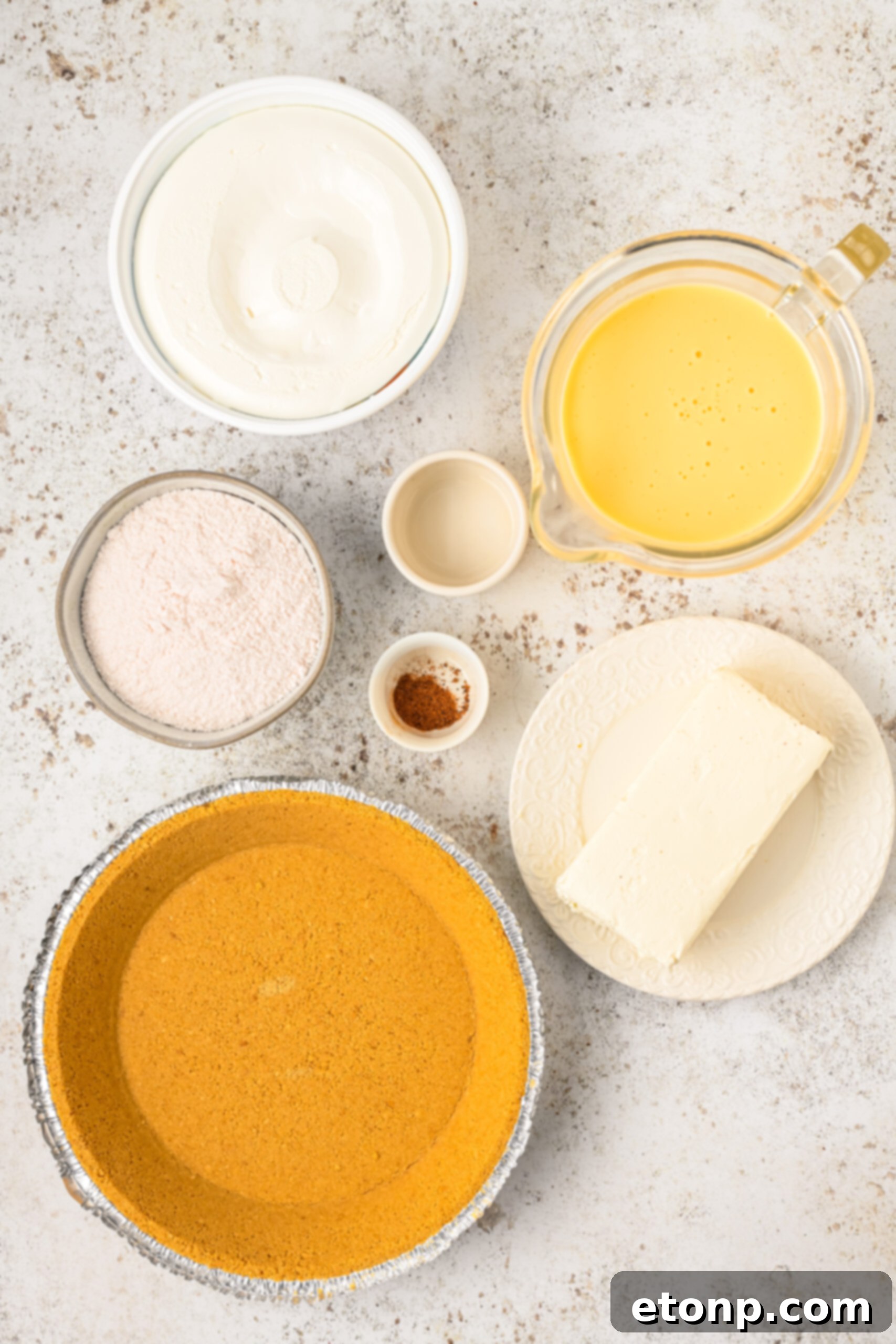 Velvety Eggnog Pie 8 Overhead view of all the pristine ingredients neatly laid out on a clean surface, ready for the Eggnog Pie recipe.