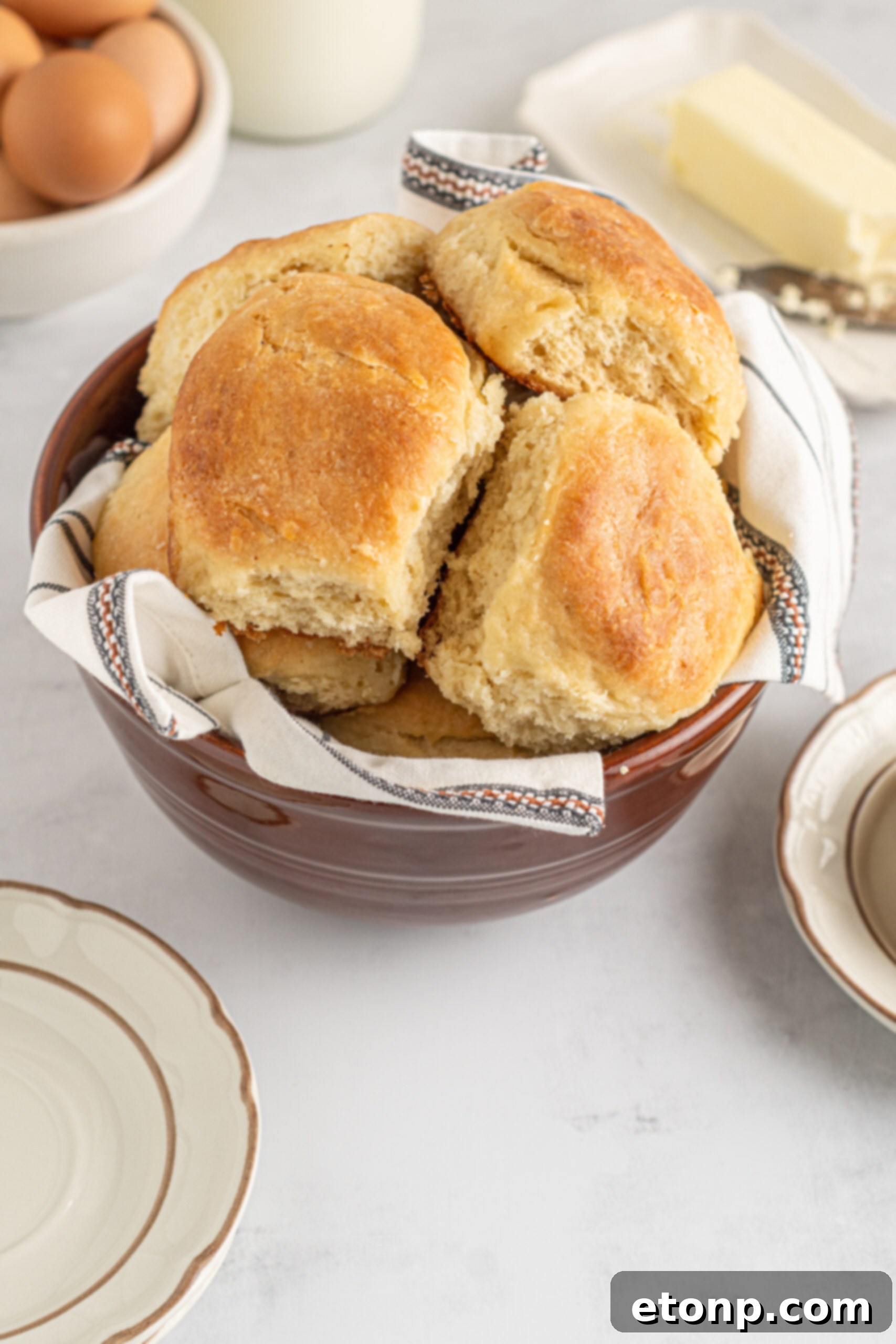 Angel Biscuits in a brown bowl with a white and black linen. 