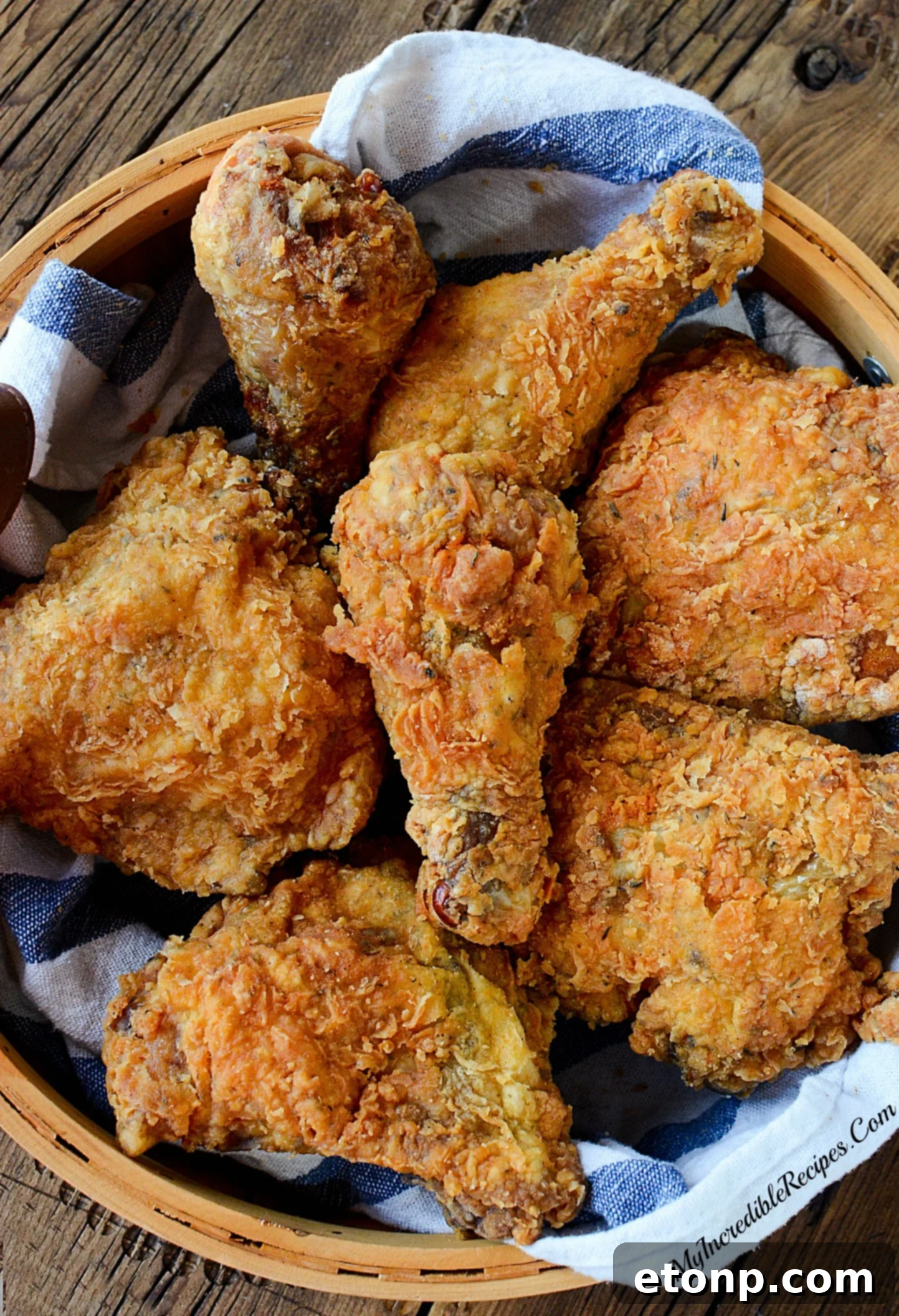 Several pieces of chicken frying in a hot skillet, bubbling oil indicating the cooking process for a crispy crust.