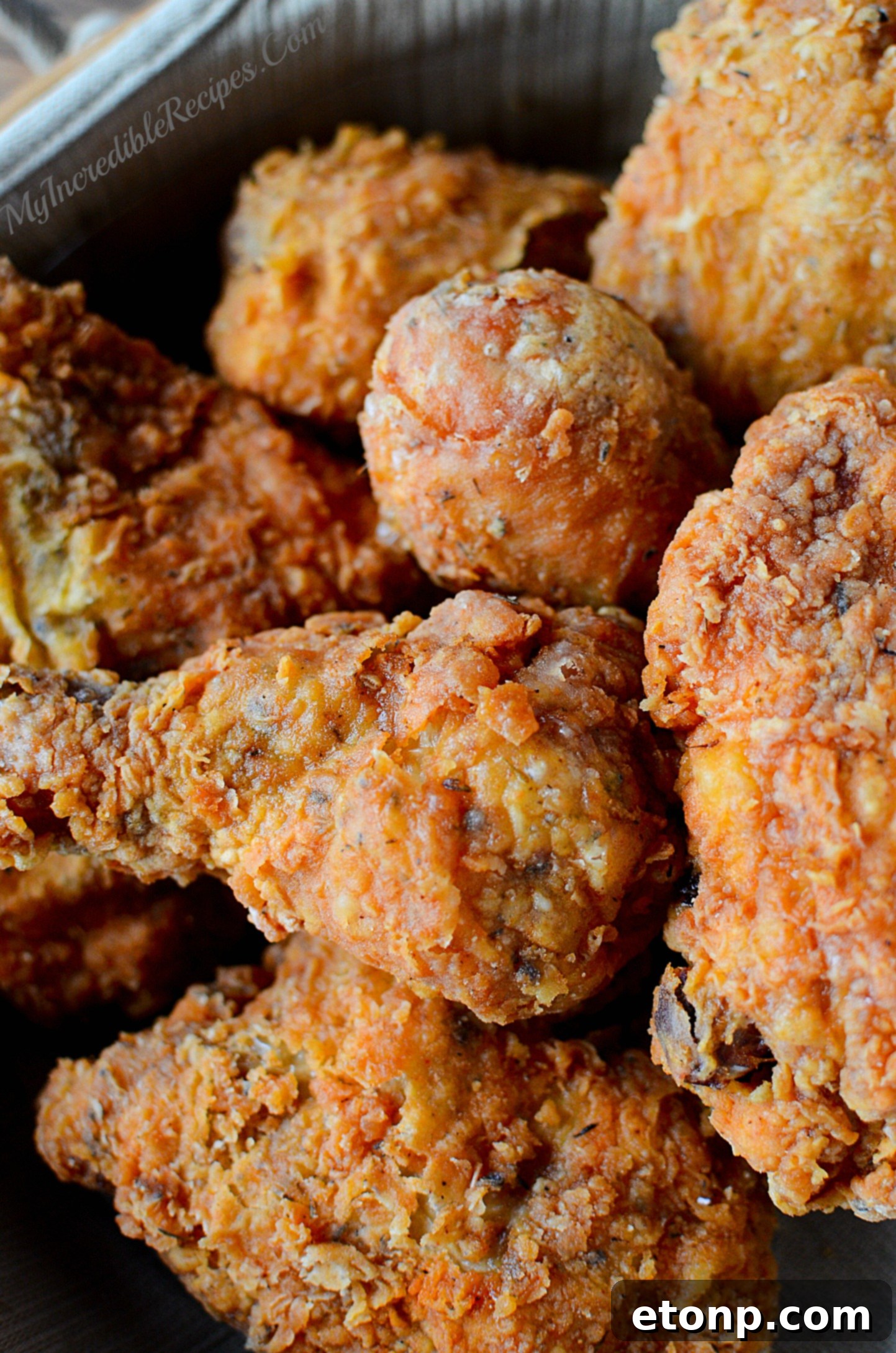 Buttermilk marinated chicken pieces, waiting to be coated, showing the readiness for the next step in the recipe.