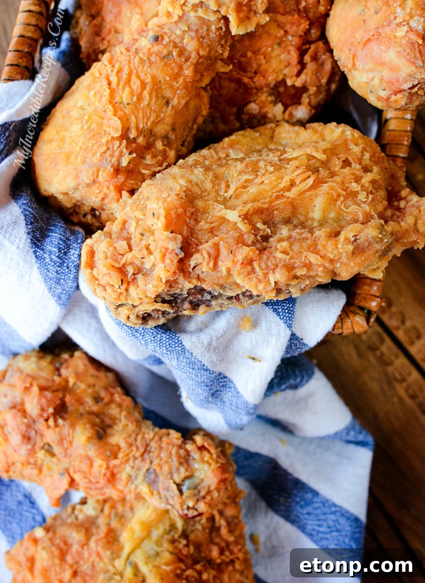 A family-sized serving of golden fried chicken, beautifully presented in a basket, ideal for gatherings and celebrations.
