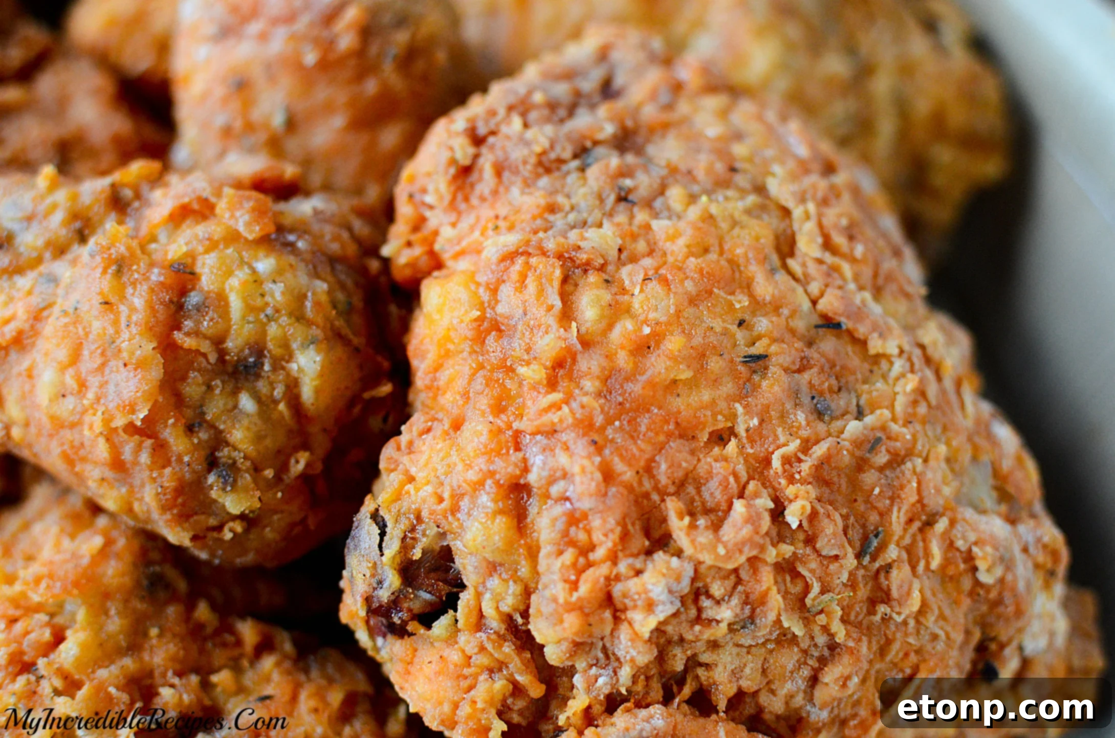 Various cuts of chicken, including legs and thighs, in a large bowl, ready for seasoning and preparation.