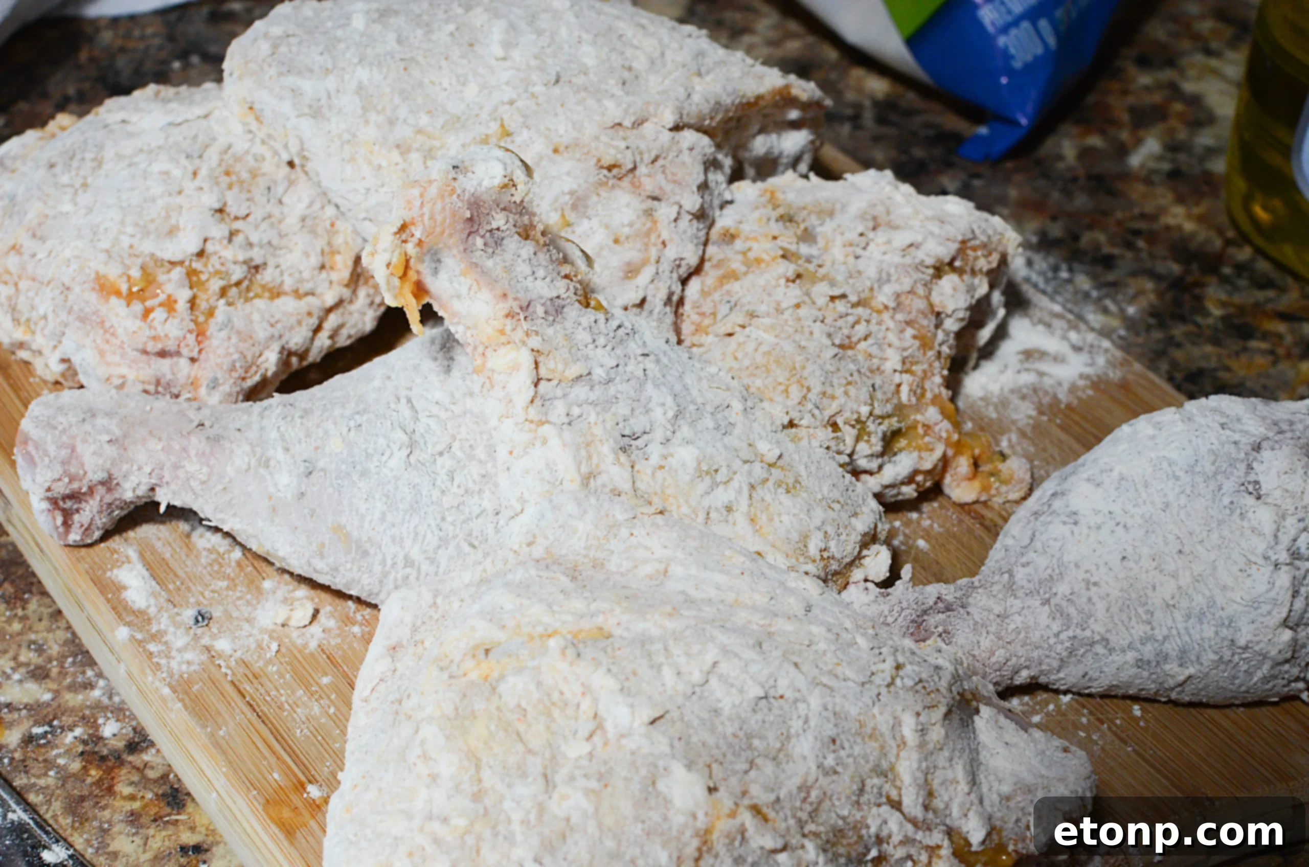 Assortment of fried chicken pieces, including drums and thighs, glistening with golden crispy coating, ready to serve.