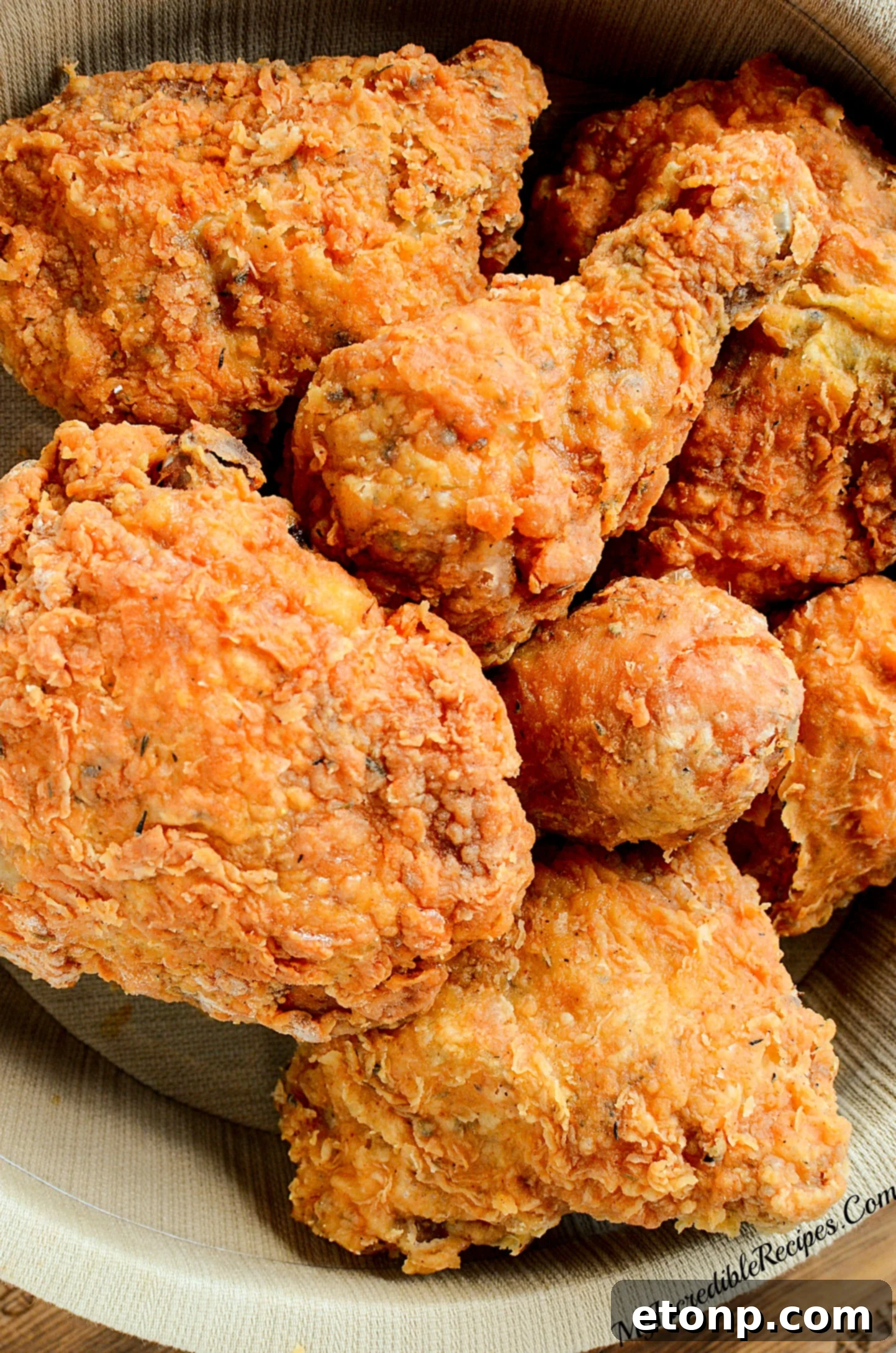 A close-up of the seasoned flour mixture in a bowl, showing the various spices ready for coating the chicken.