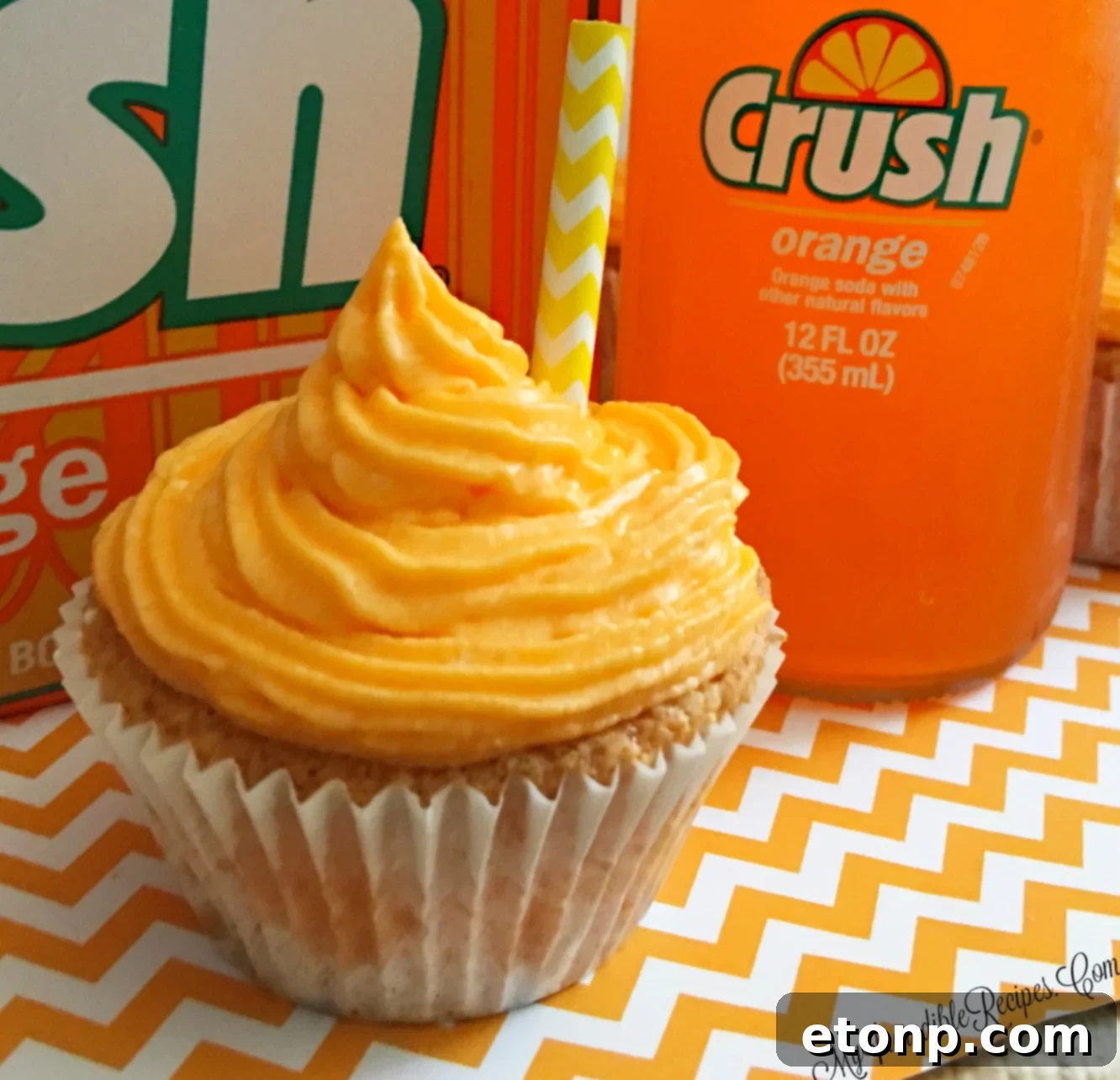 Zesty orange creamsicle cupcakes with a vibrant orange and white swirl frosting, reminiscent of a classic summer treat.
