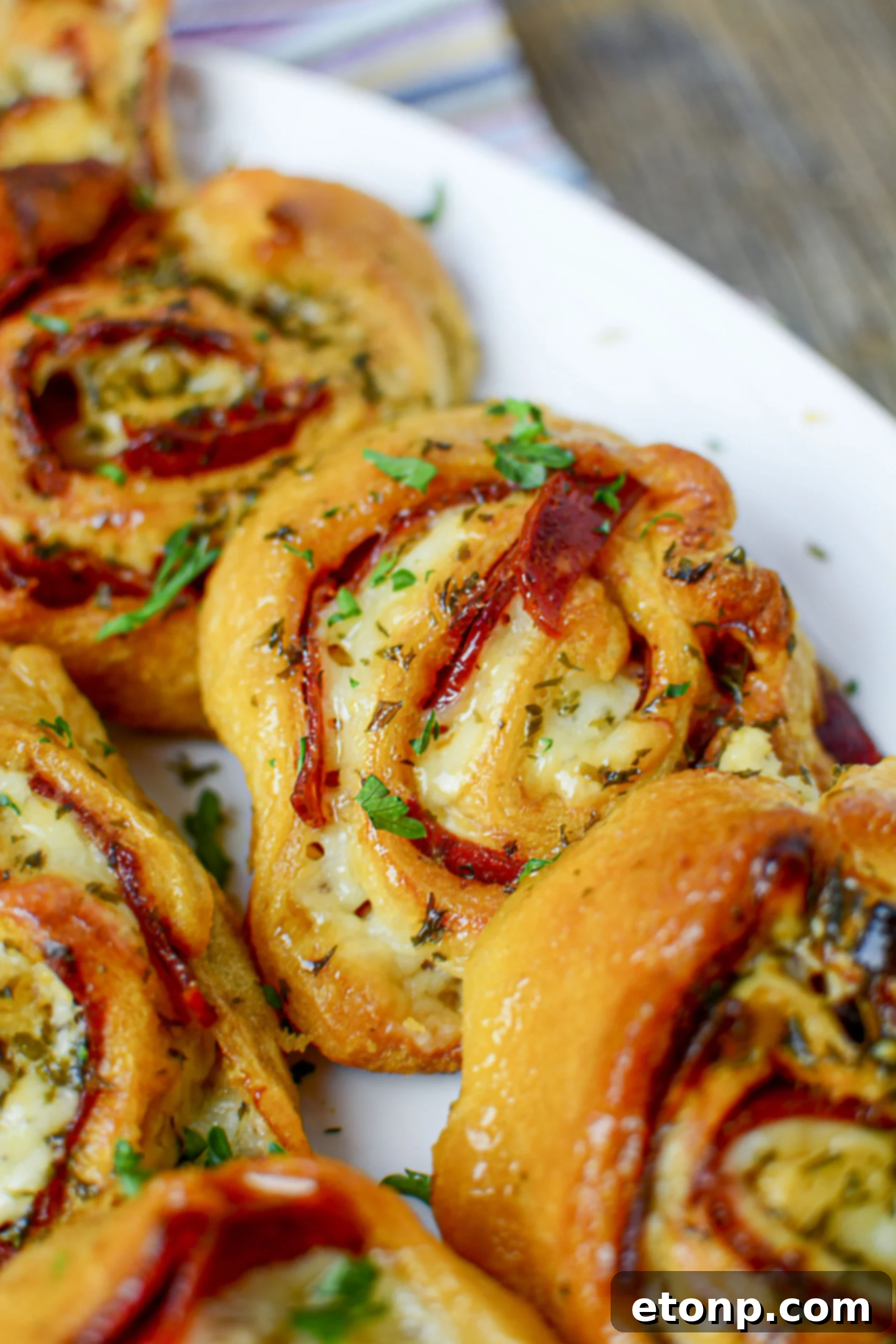 Pizza Swirls 5 Ingredients for pizza pinwheels: crescent rolls, pizza sauce, shredded cheese, and pepperoni laid out on a kitchen counter.