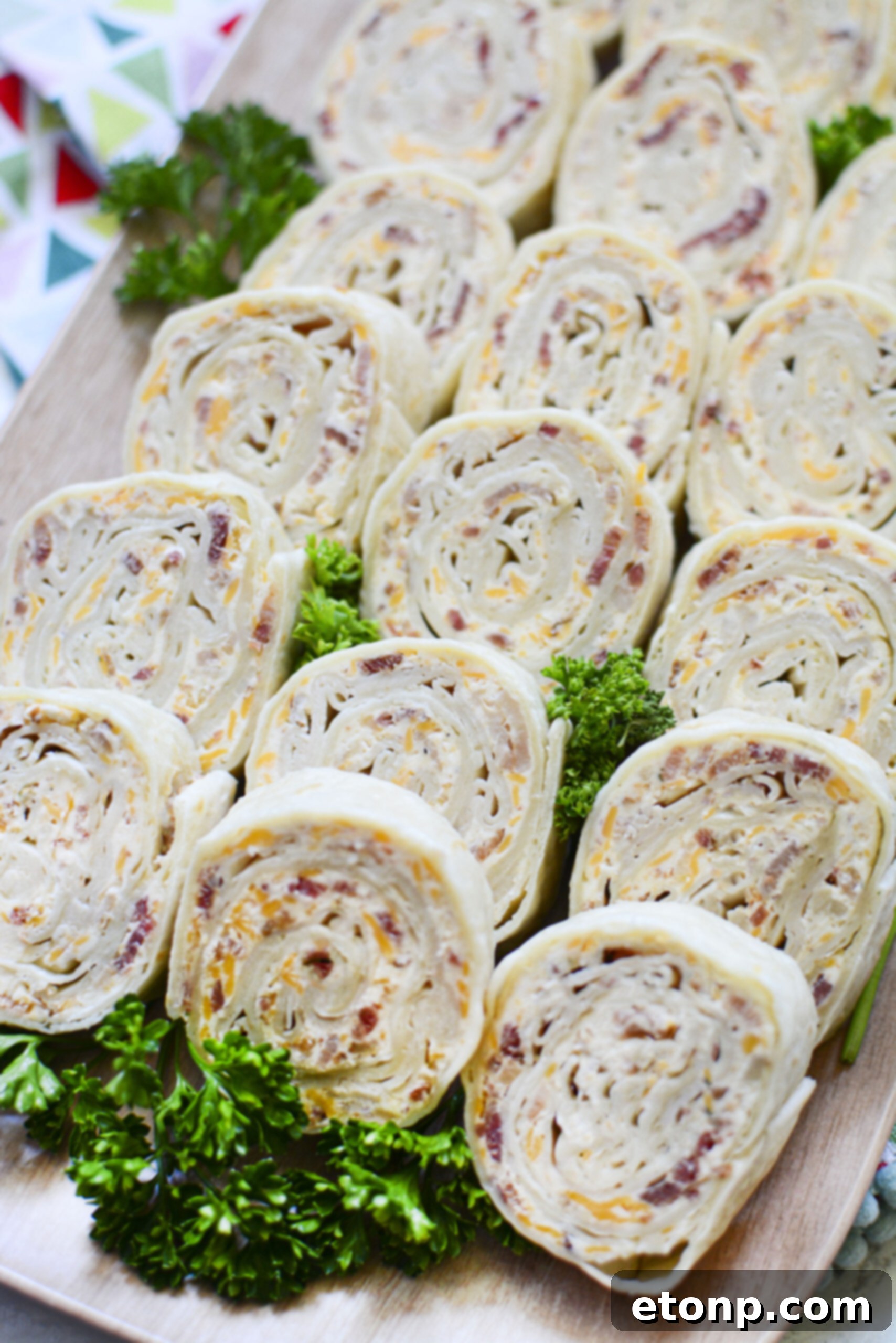 Close-up overhead shot of a platter of turkey pinwheels, cut into perfect spirals.