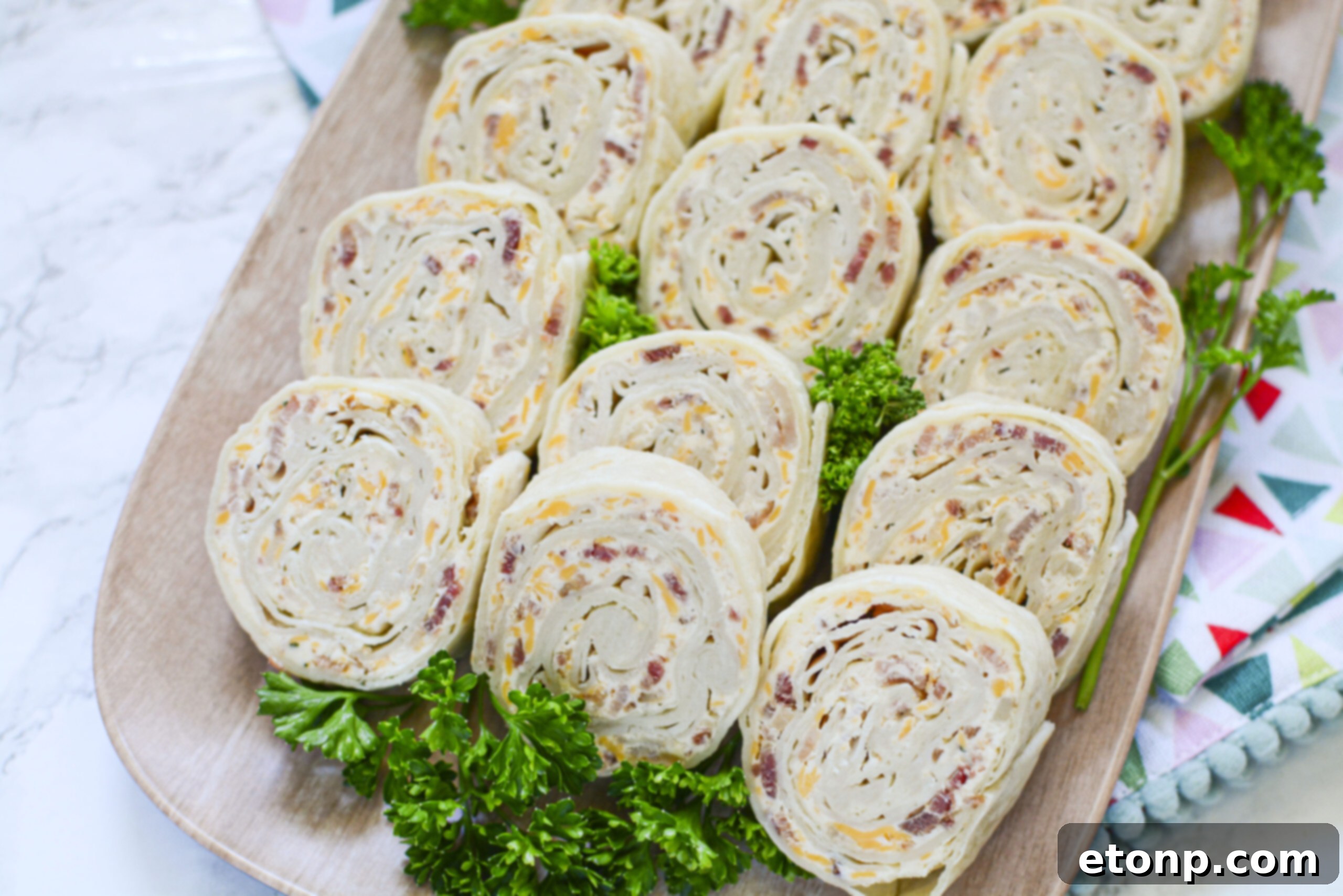 Close-up shot of turkey pinwheels on a platter, ready to be served.