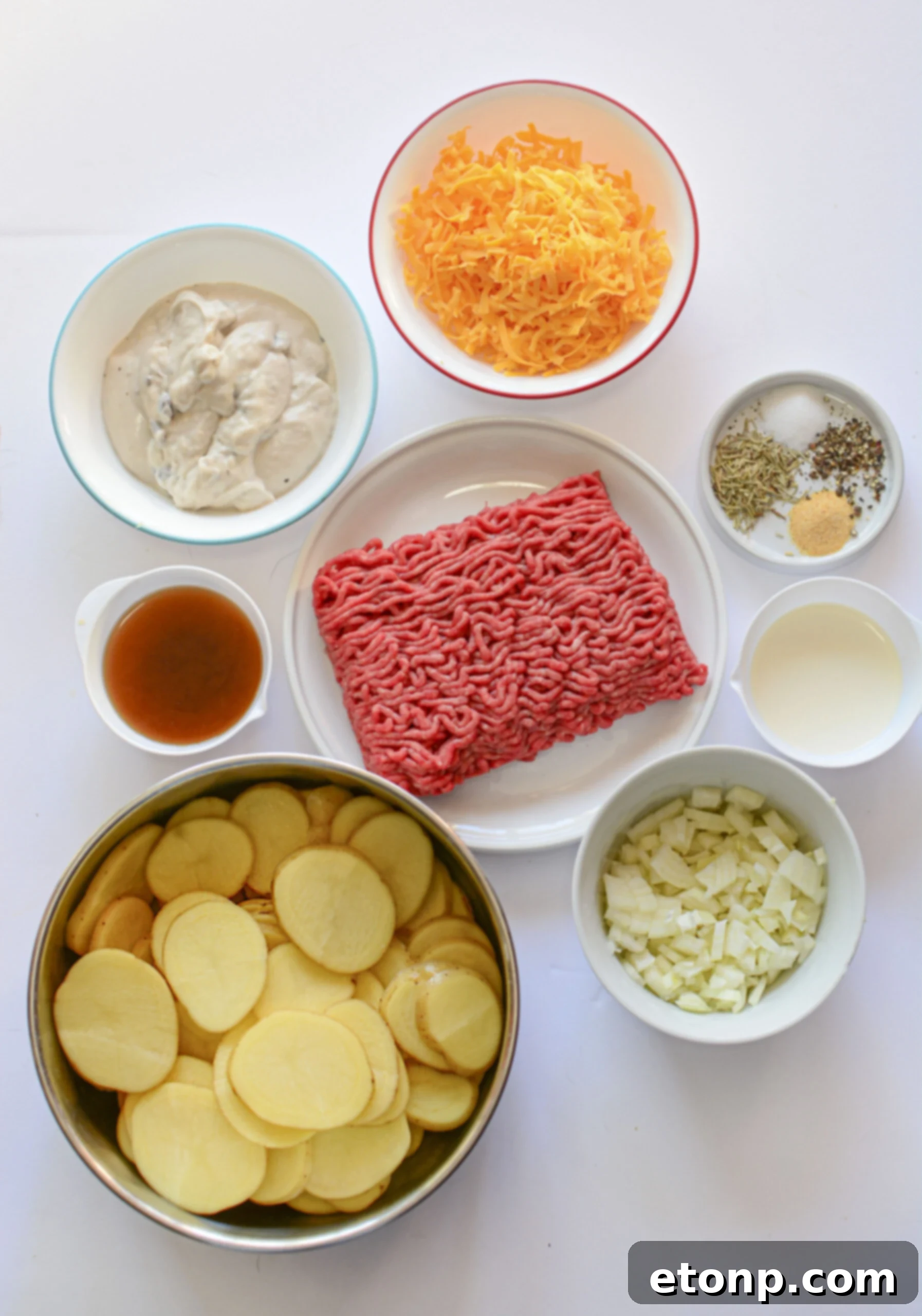 An overhead shot showcasing all the fresh ingredients laid out for preparing the Cheesy Ground Beef and Potato Casserole.