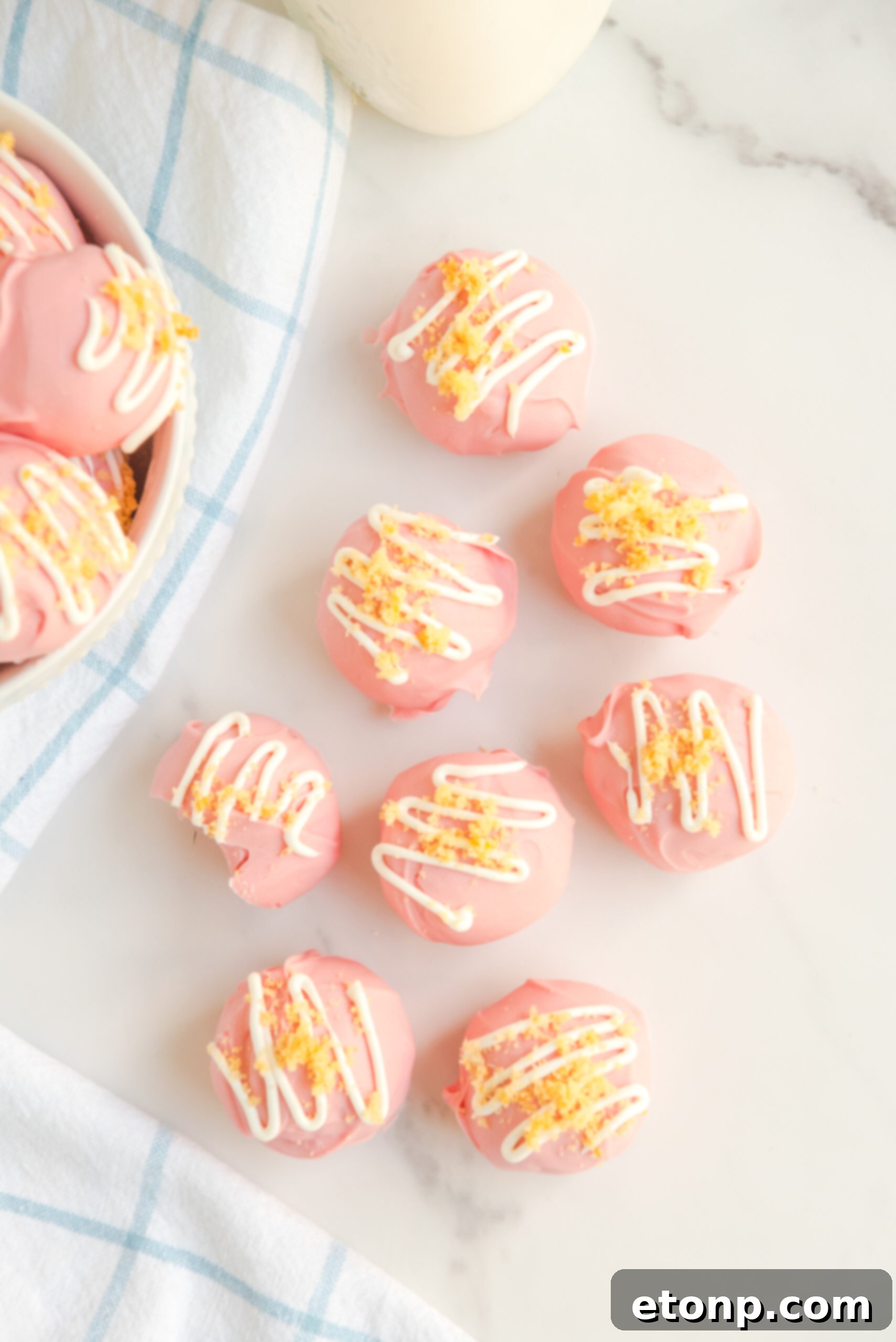 Overhead view of strawberry shortcake truffles on a stylish marble backdrop, highlighting their elegant presentation.
