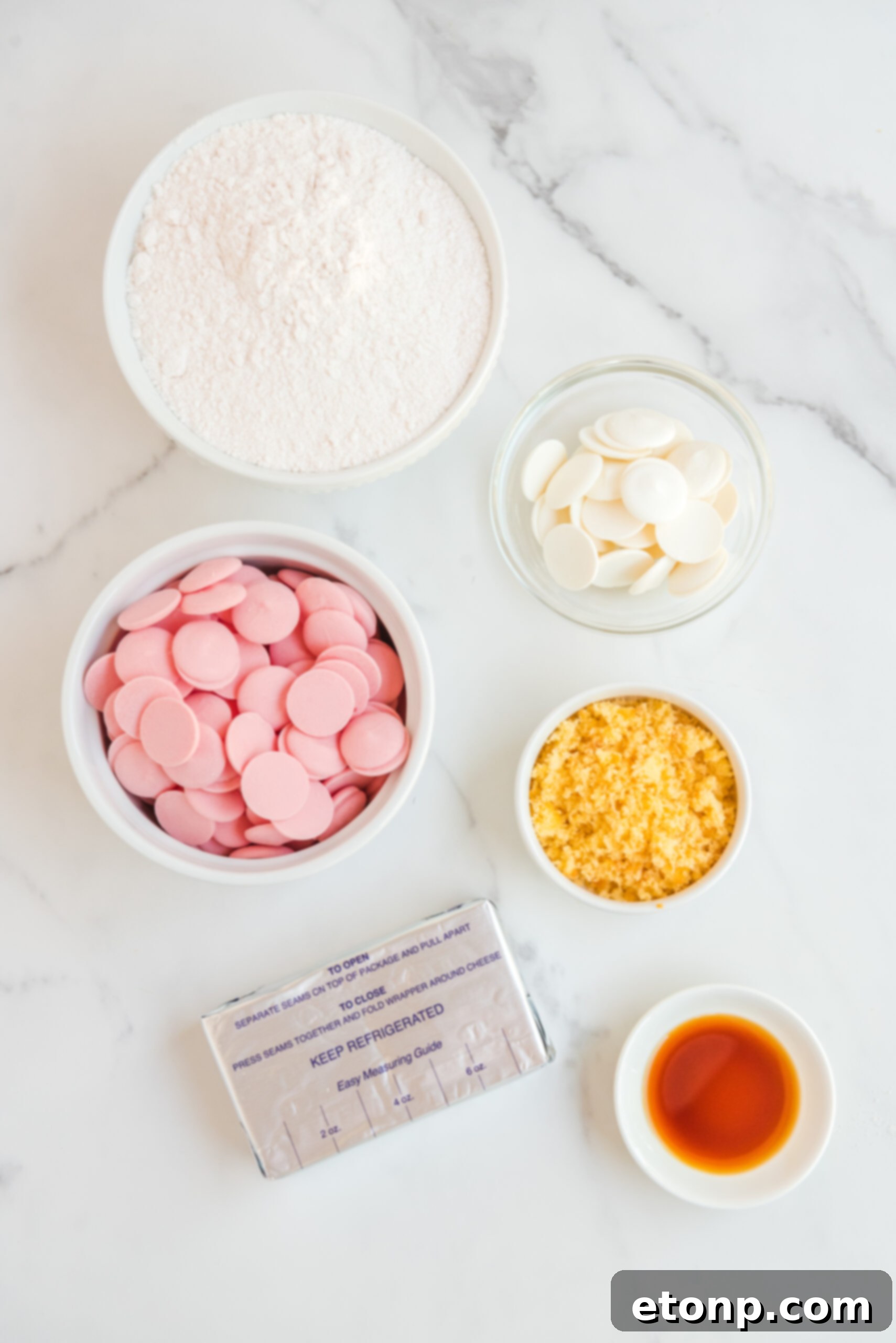 Overhead view of all the ingredients laid out for making strawberry shortcake truffles, including cake mix, cream cheese, vanilla, and candy melts.