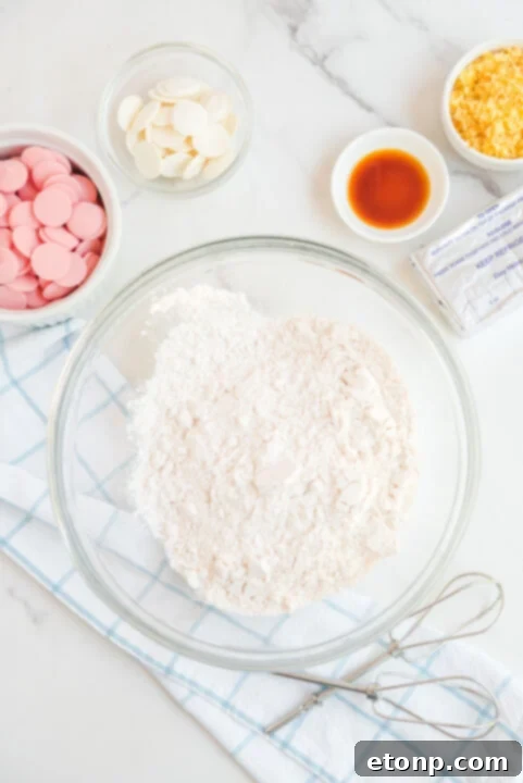 Step-by-step image of combining cake mix, cream cheese, and vanilla.