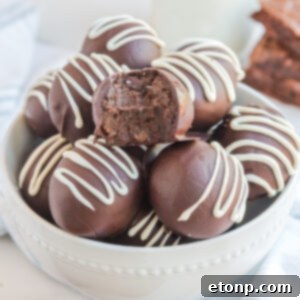 A delicious brownie truffle, coated in chocolate and drizzled with white chocolate.