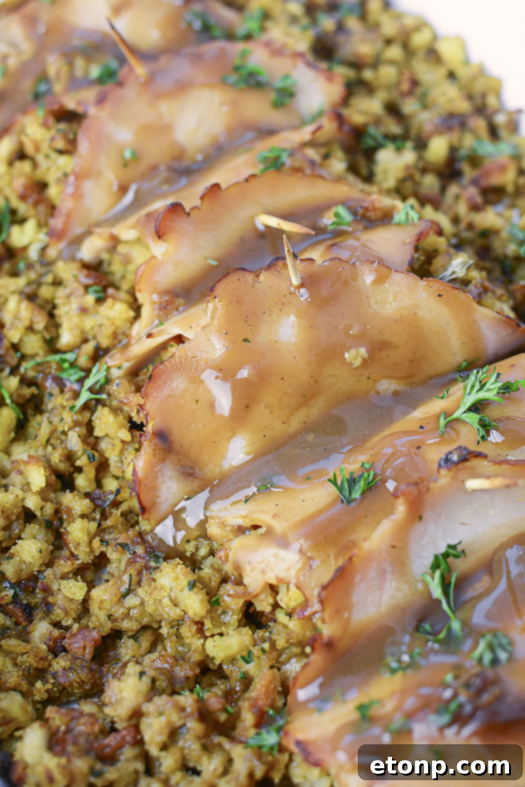 Up Close view of turkey stuffing rolls topped with gravy. 