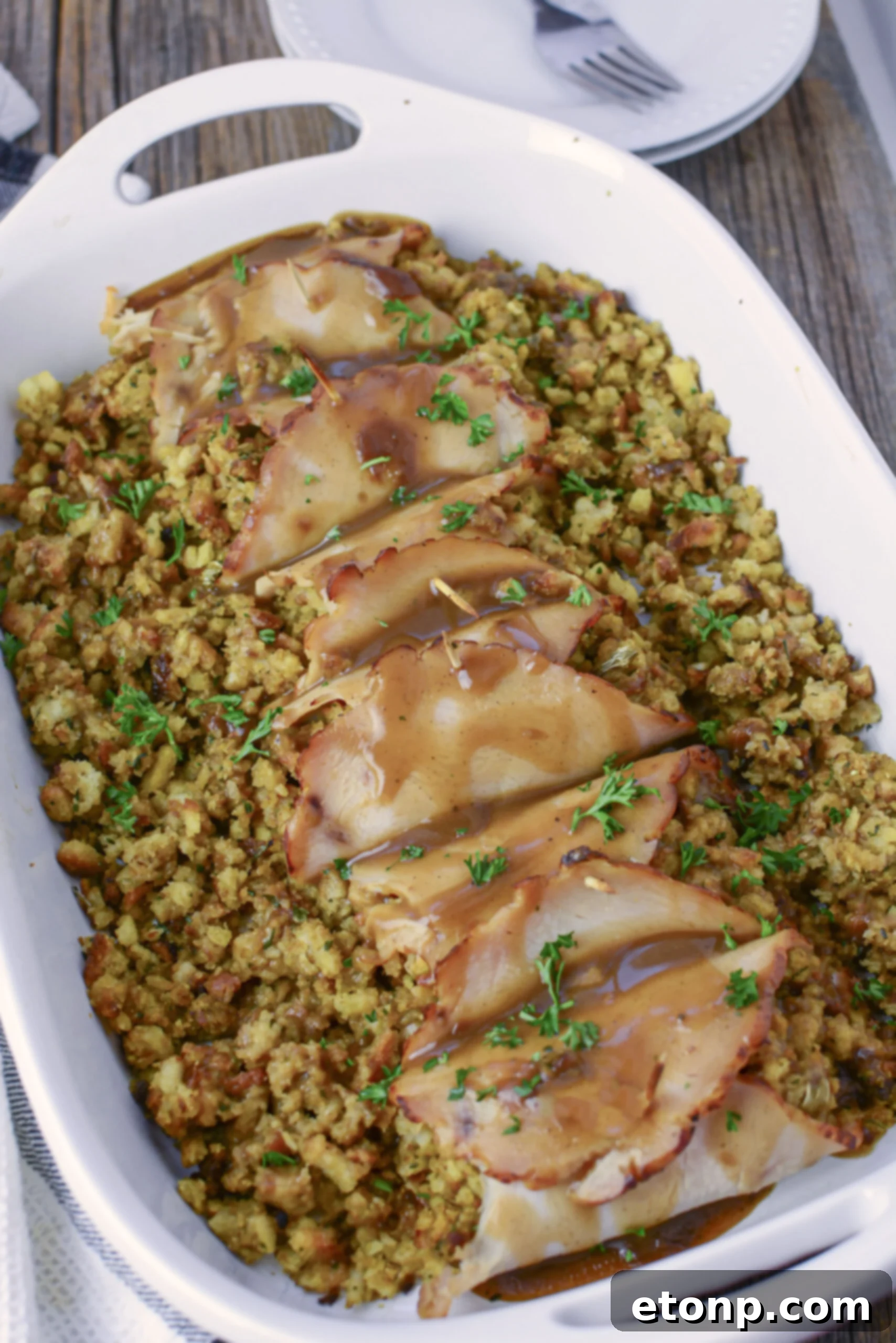 Turkey Stuffing Roll Ups on a white plate with mashed potatoes