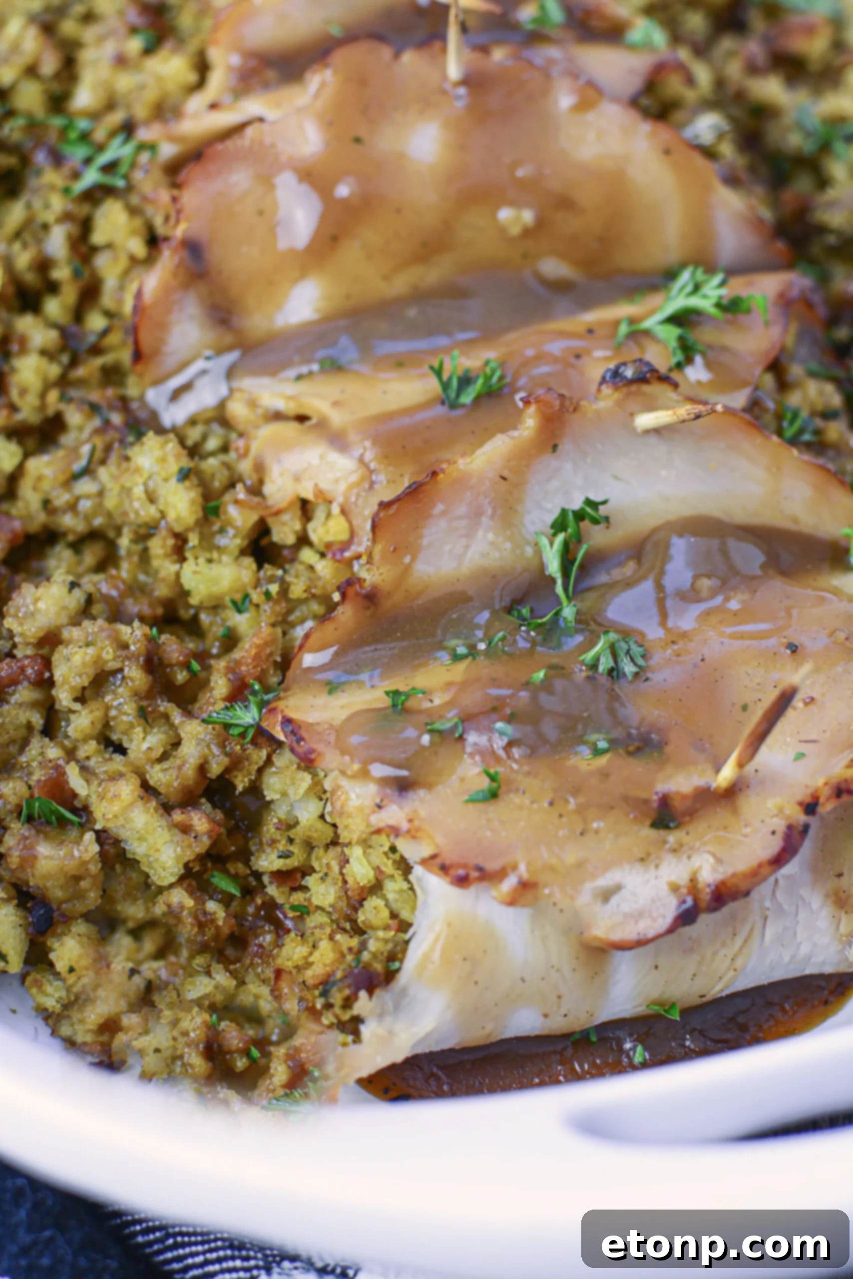 Up Close view of turkey stuffing rolls topped with gravy. 