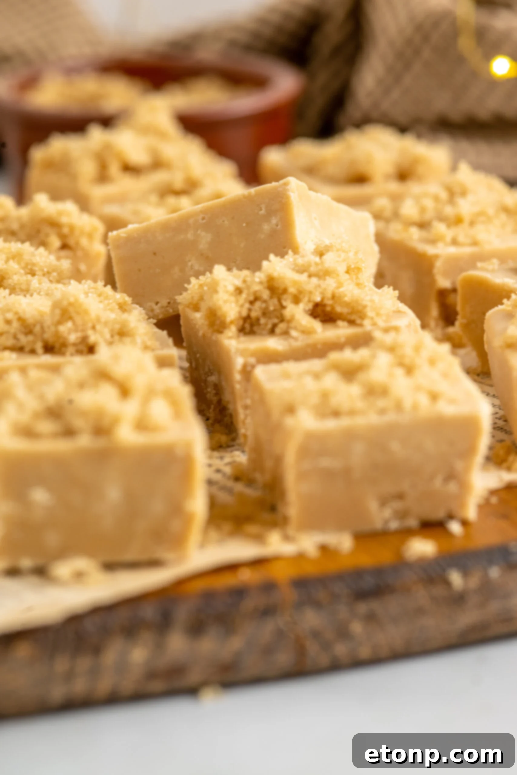 Golden Caramel Fudge 4 Side view of Penuche Fudge on a wooden board.