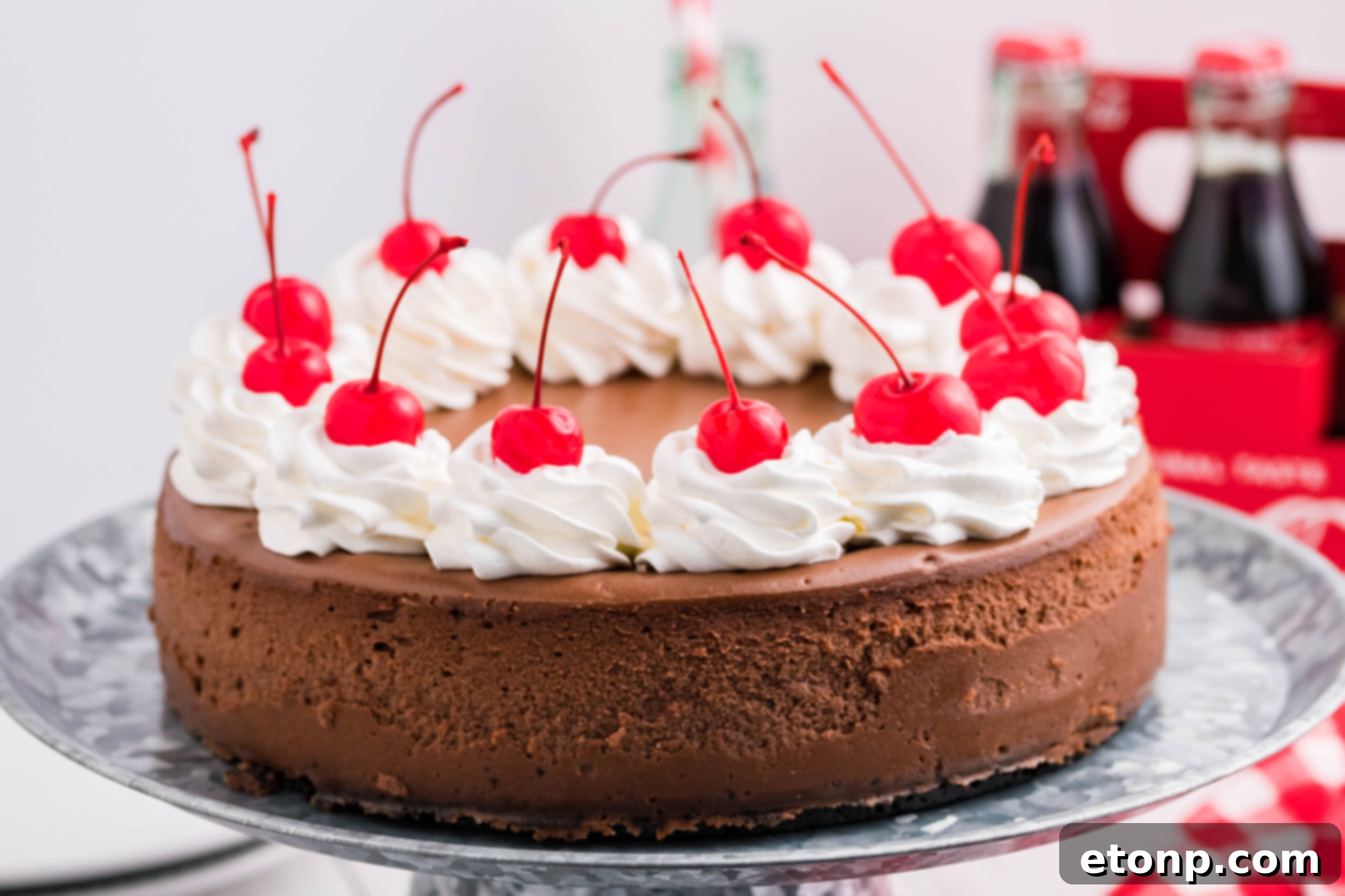 Decadent Coca-Cola Cheesecake 4 Side view of Coca Cola Cheesecake on a galvanized cake pan.