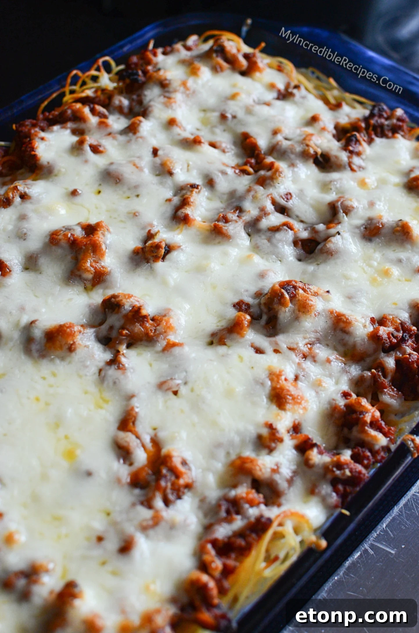 Crown Jewel Spaghetti 10 Generous amount of shredded cheese being added to Million Dollar Spaghetti