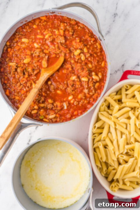 A creamy cheese sauce being prepared in a saucepan.