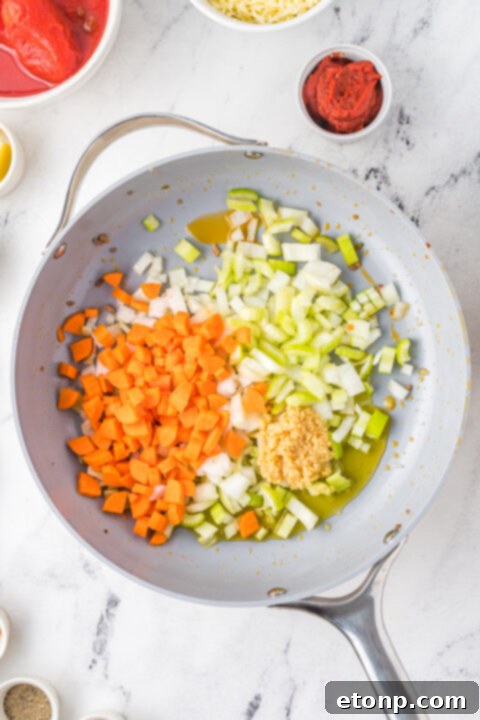 Diced onions and garlic sautéing in a pan for the sauce base.