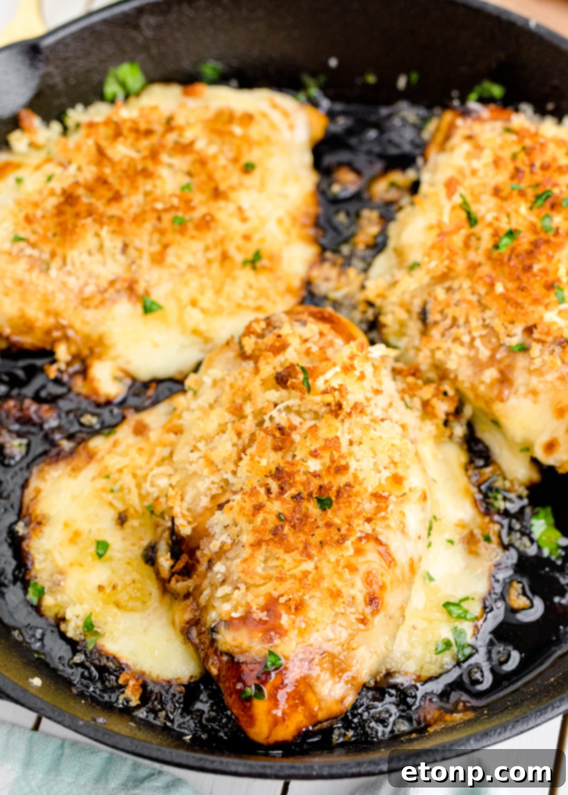 Crispy Parmesan Chicken 2 Parmesan Crusted Chicken (Longhorn Copycat) in a cast iron skillet, golden brown and perfectly cooked.