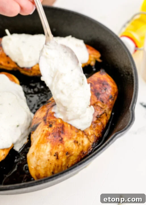 Crispy Parmesan Chicken 11 Placing slices of provolone cheese on top of chicken breasts.