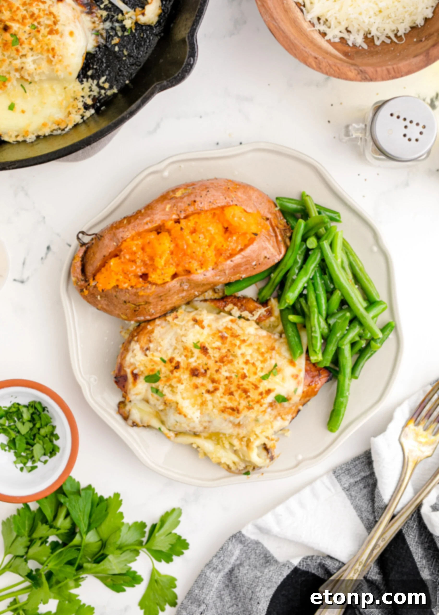 Crispy Parmesan Chicken 16 Overhead view of Parmesan Crusted Chicken (Longhorn Copycat) on a white dish, elegantly served with fresh green beans and a hearty baked sweet potato, highlighting a complete meal.