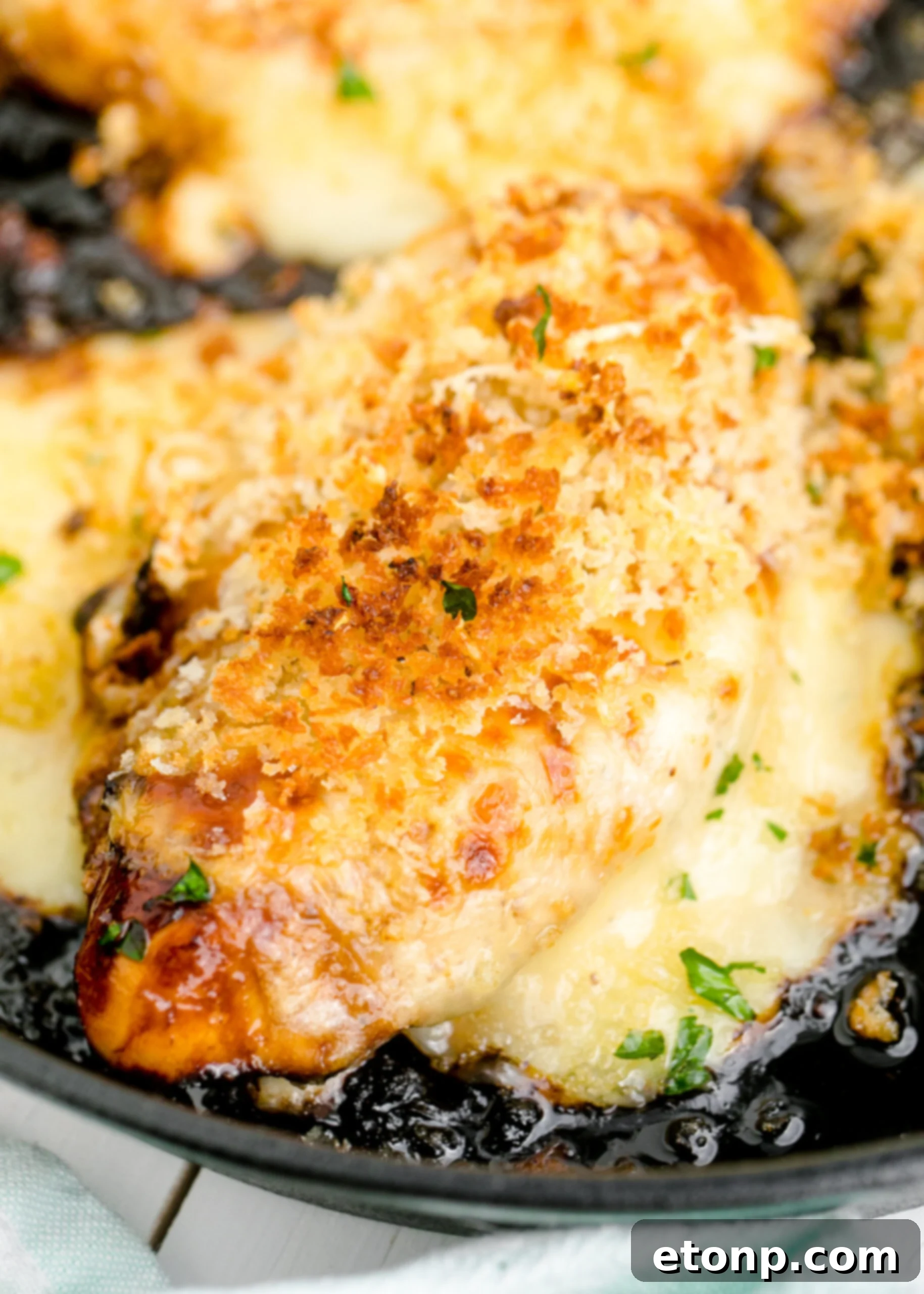 Crispy Parmesan Chicken 17 Close up view of the crispy, golden Parmesan Crusted Chicken (Longhorn Copycat) in a cast iron skillet, ready to be portioned.