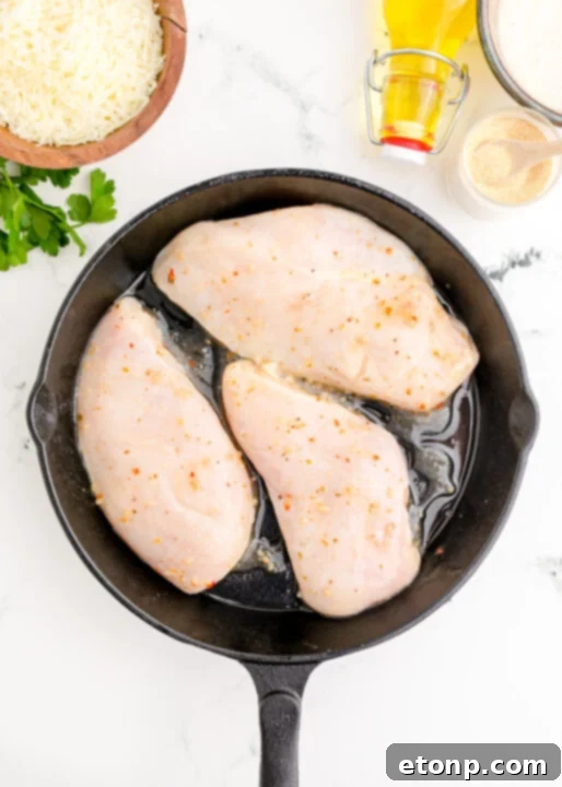 Crispy Parmesan Chicken 10 Applying creamy parmesan and ranch dressing mixture to seared chicken.