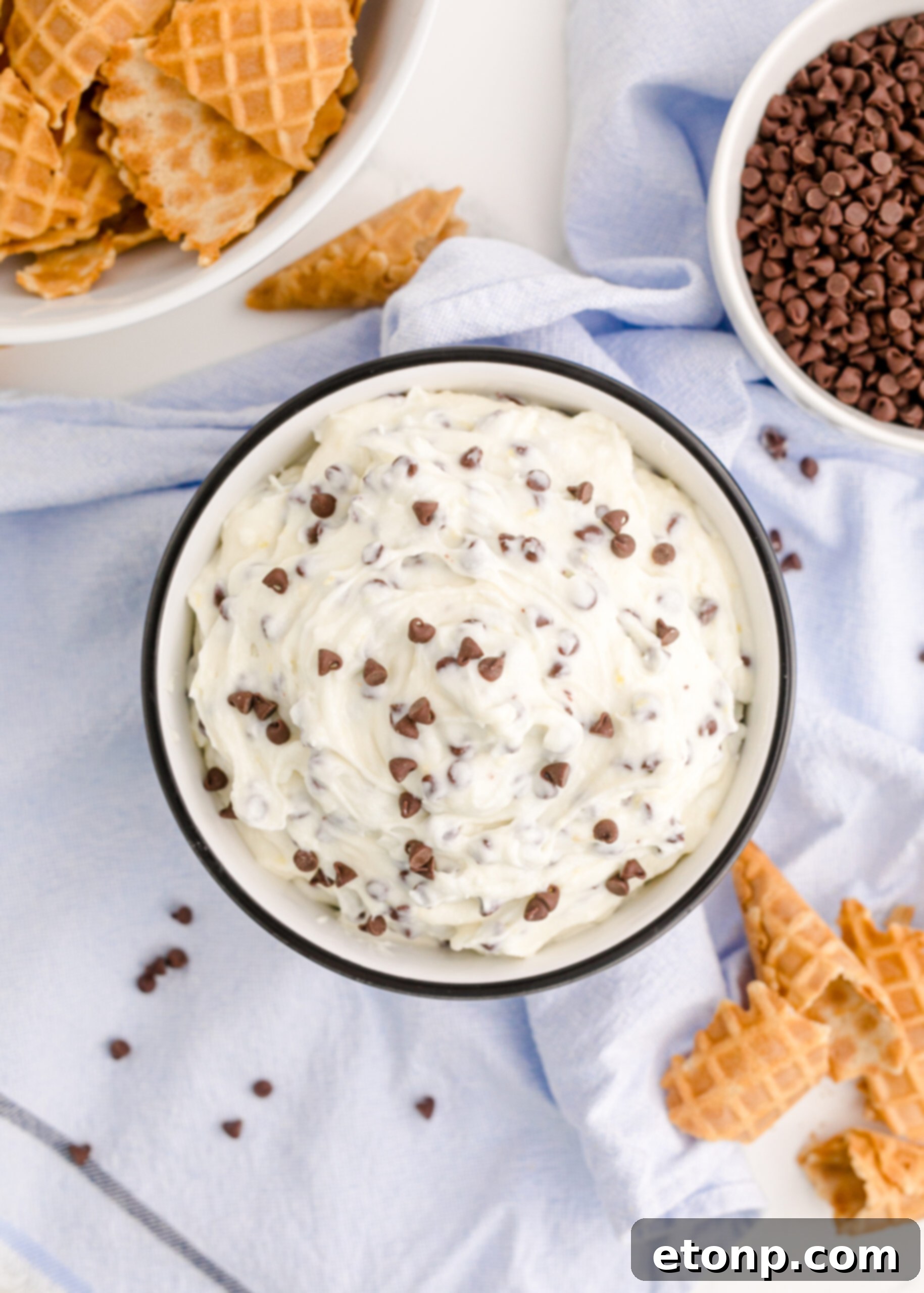 An overhead shot of the creamy Cannoli Dip, showing its smooth texture and rich color, presented in a black and white serving dish.