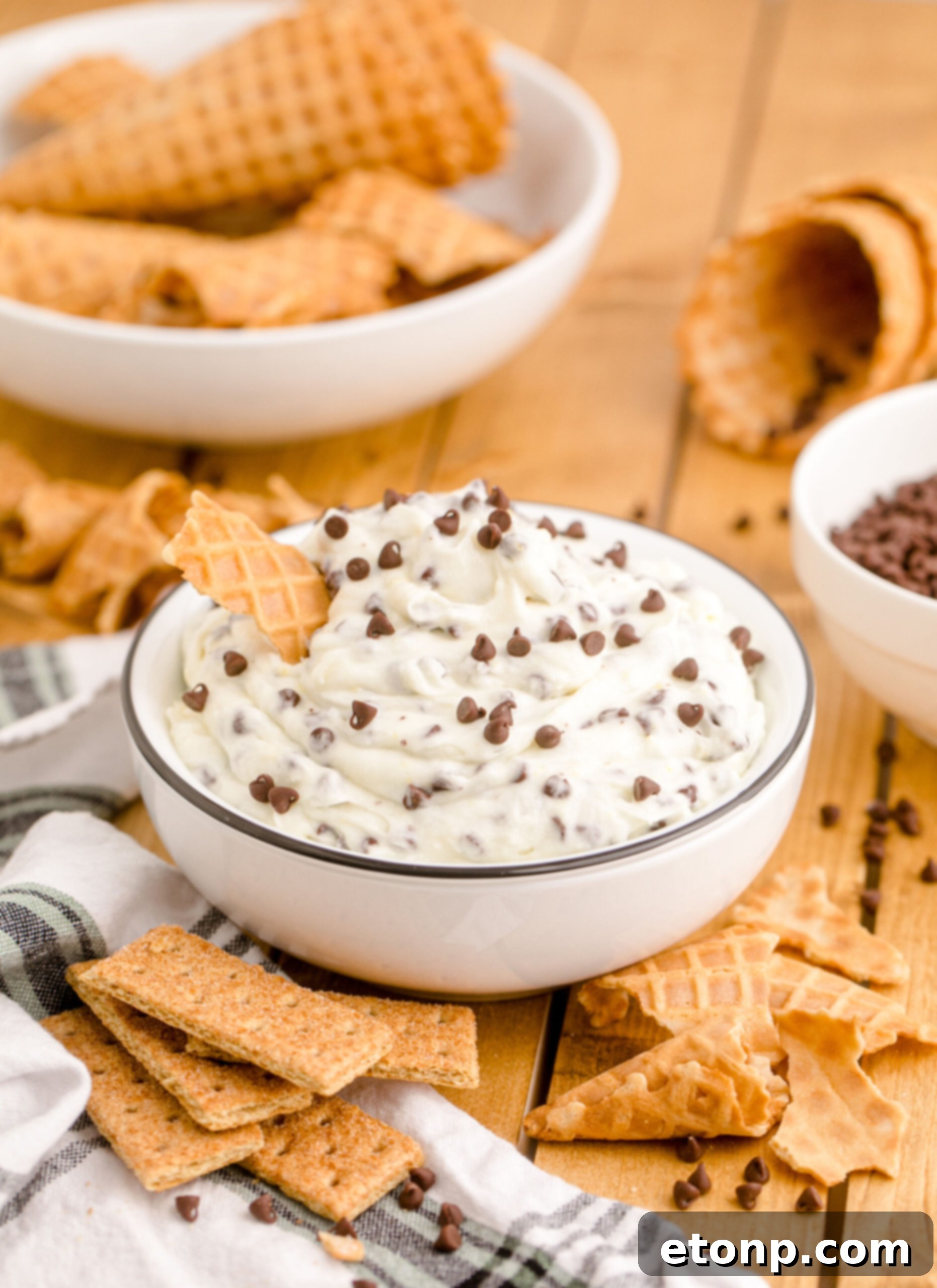 A close-up shot of the freshly prepared Cannoli Dip, showcasing its smooth, creamy texture and the appealing distribution of mini chocolate chips, ready for chilling.