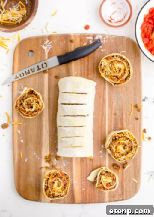 An overhead shot of a few baked Taco Pinwheels presented on a plate, ready to be served and enjoyed.