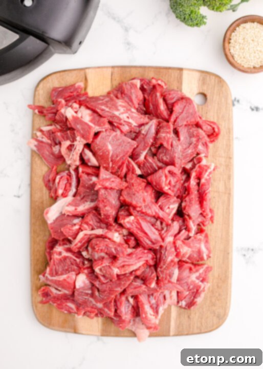 A vibrant close-up of tender beef strips and fresh broccoli florets covered in a rich, glossy sauce.