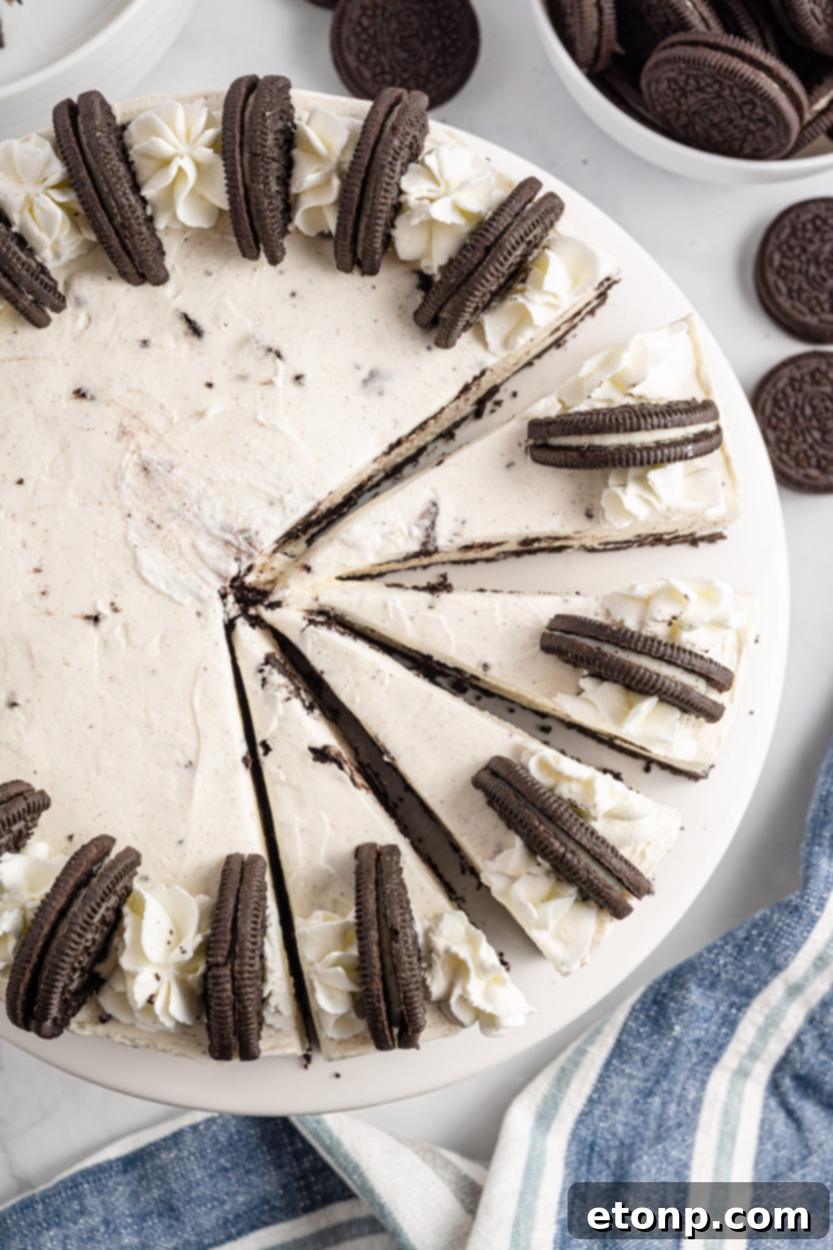 No-Bake Oreo Cheesecake Magic 3 Overhead view of a beautiful No Bake Oreo Cheesecake, with four tantalizing slices already cut, ready to be served.