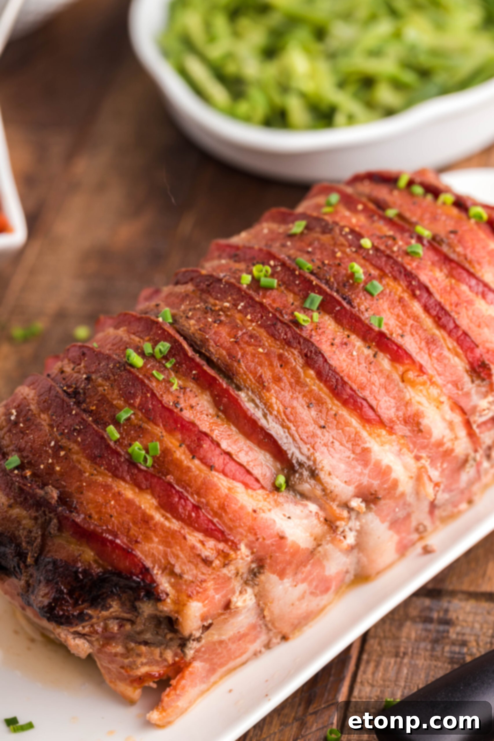 Bacon-Cloaked Meatloaf 15 Bacon Wrapped Meatloaf up close uncut showing the crispy bacon