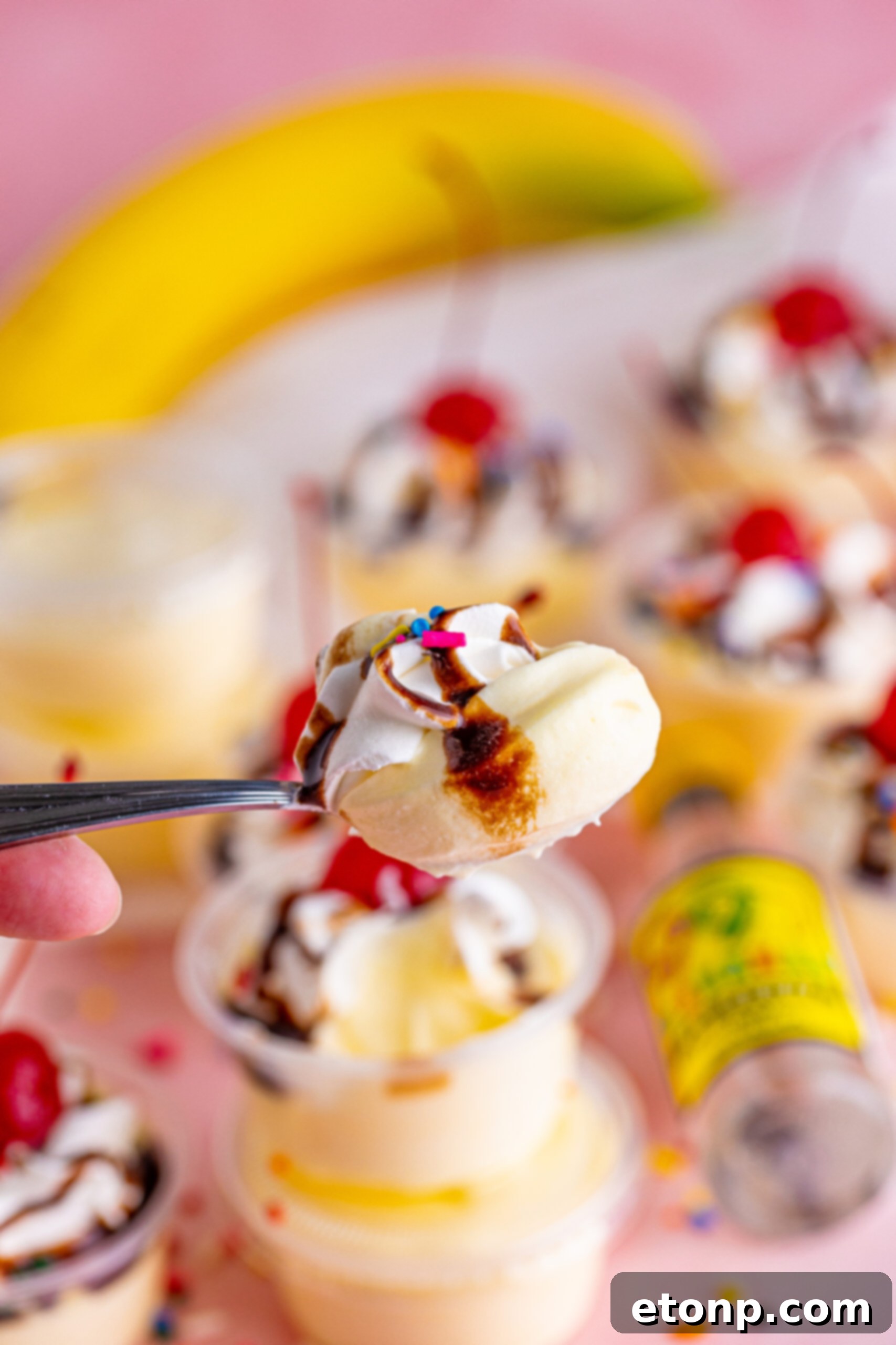 Silver spoon with a spoonful of Banana Split Shots.