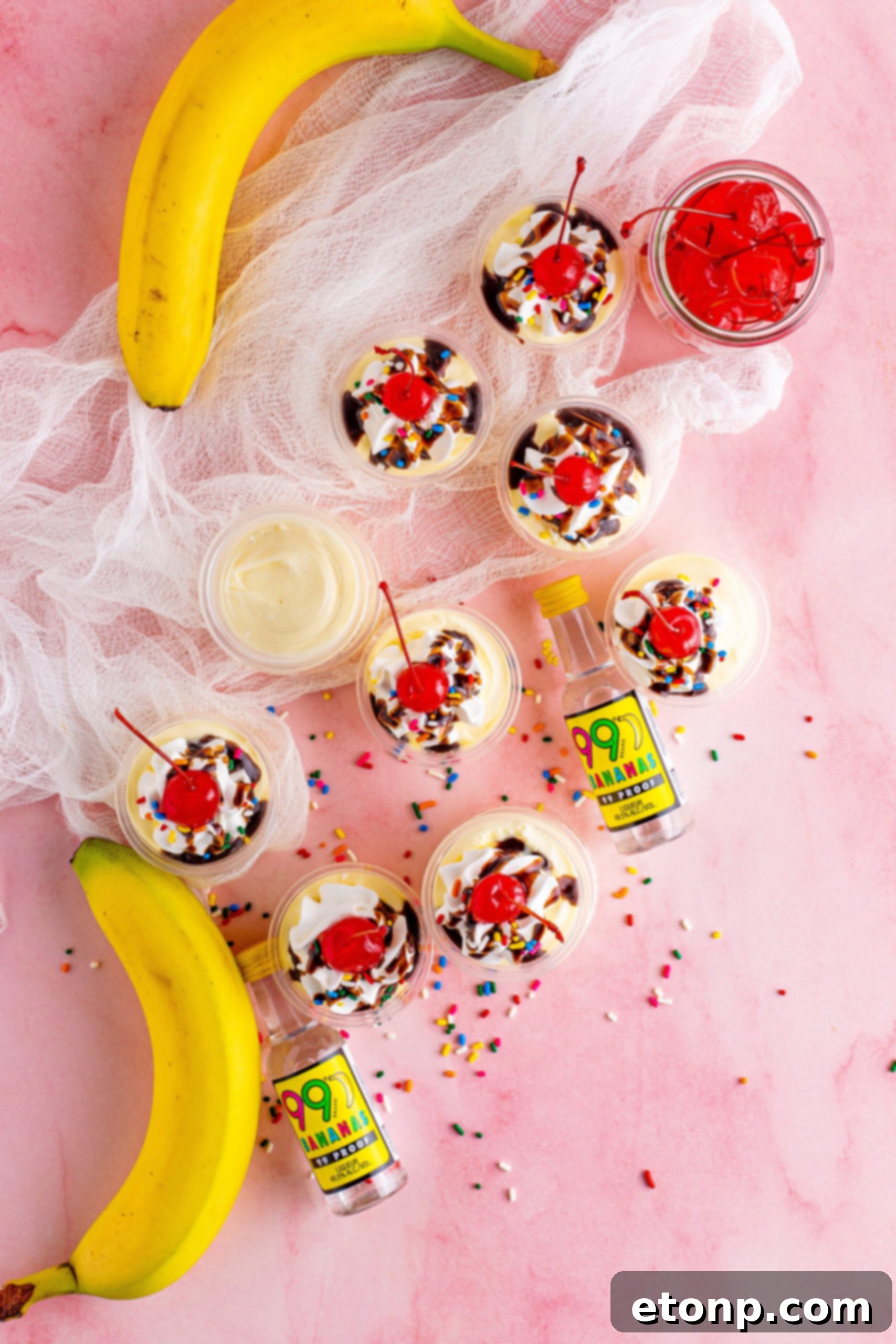 Overhead view of Banana Split Shots surrounded by rainbow sprinkles.