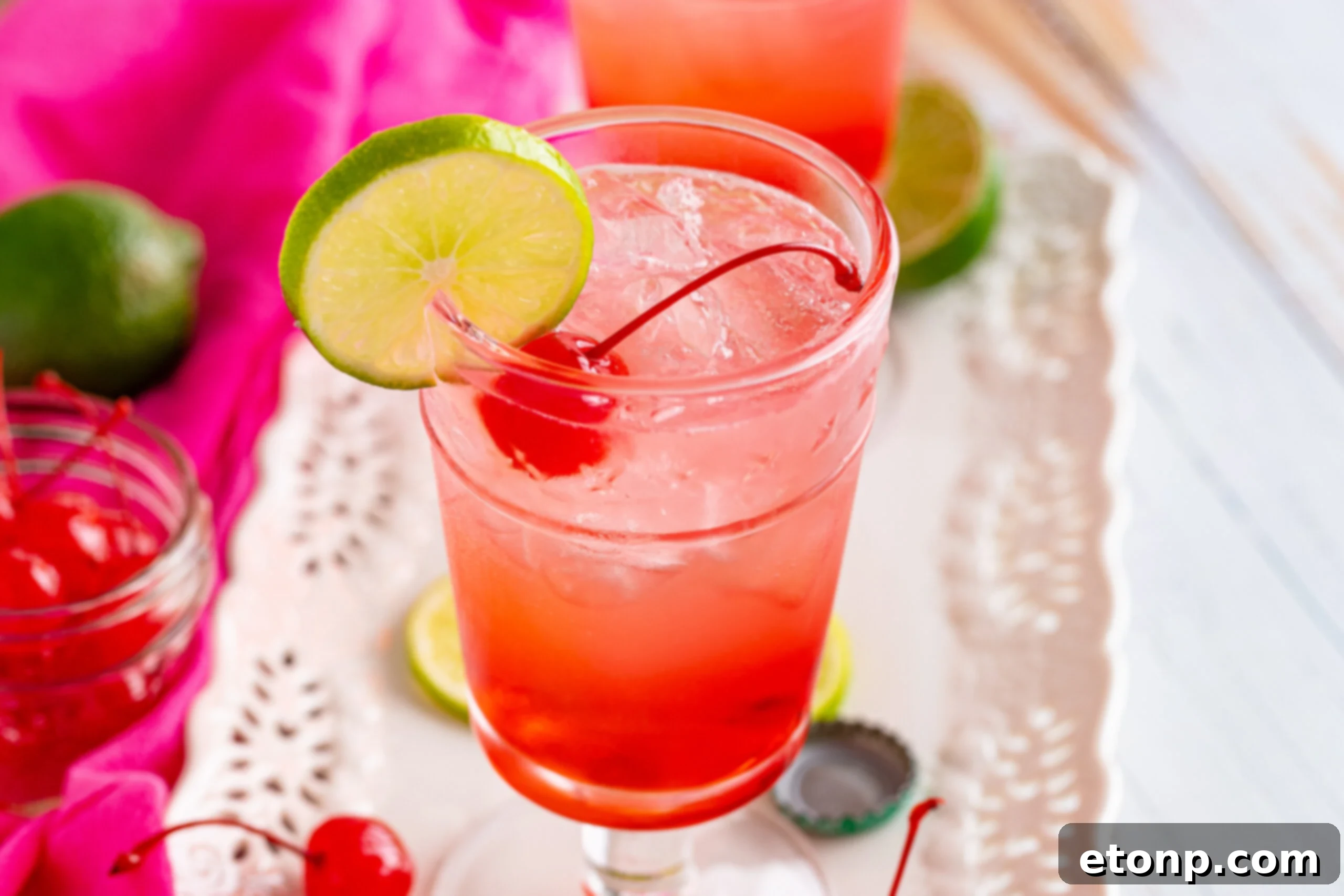 45 degree view of Dirty Shirley Temple garnished with a lime slice.