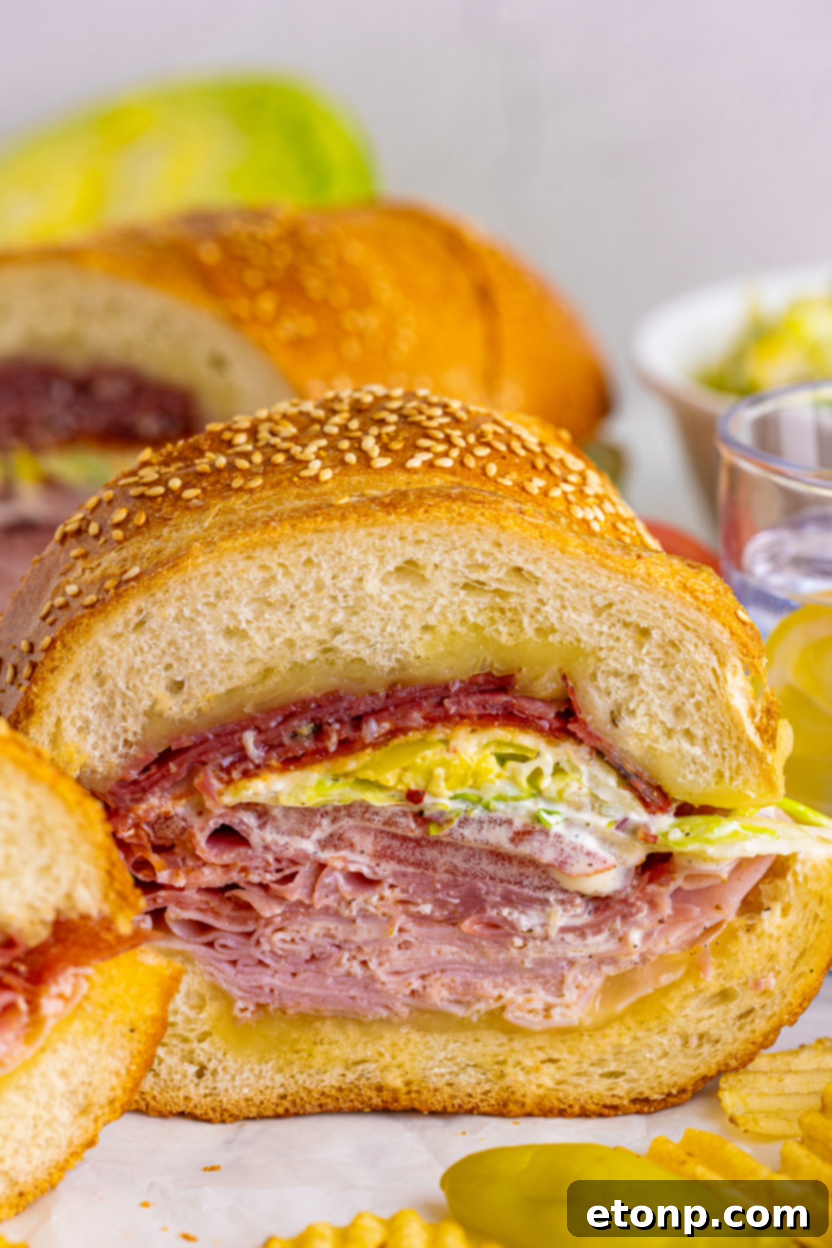 Toasted Grinders 17 An extreme close-up of a Grinder Sub, showcasing the intricate layers of deli meats, melted cheese, and fresh grinder salad.
