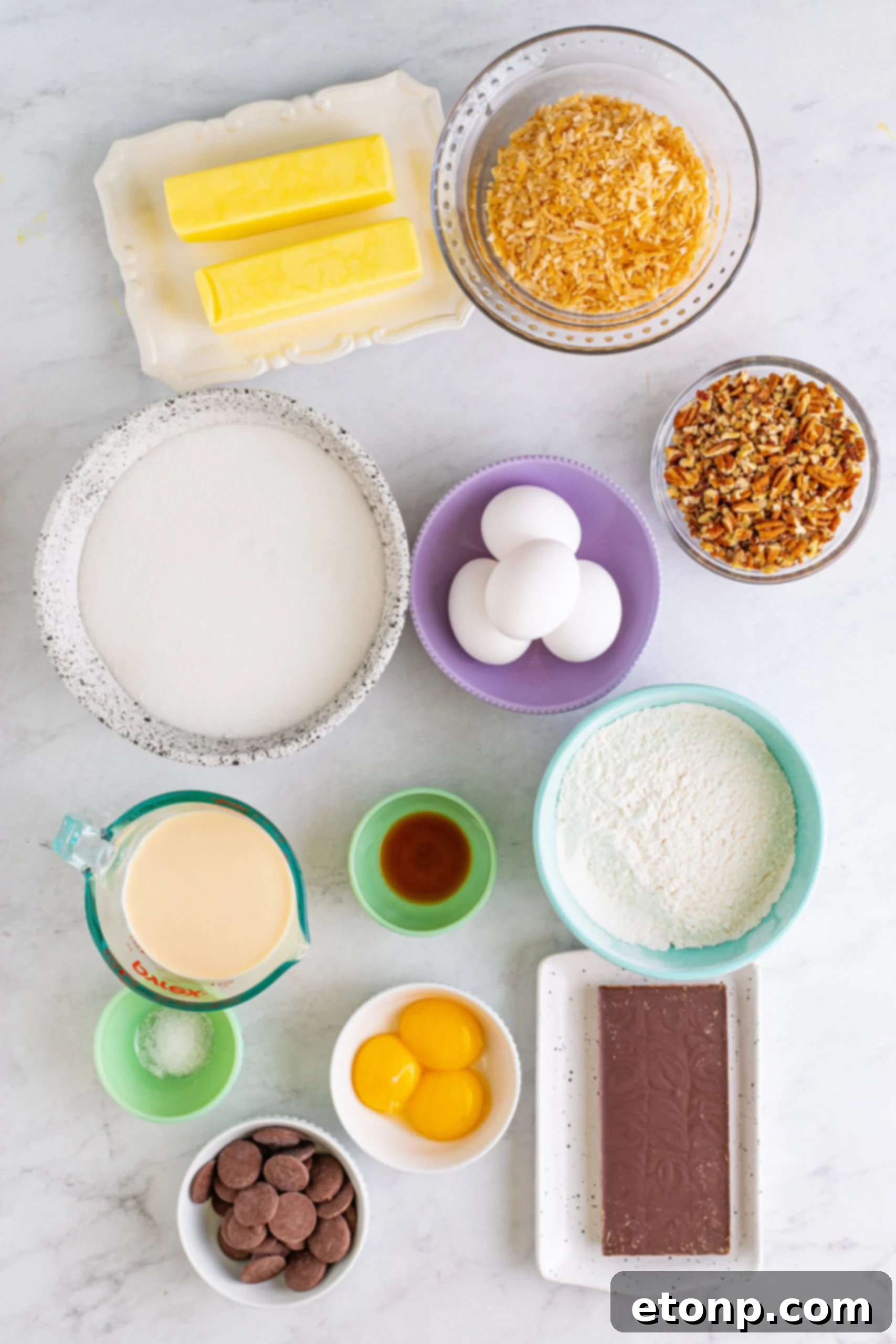 Overhead view of all the raw ingredients required to prepare the German Chocolate Brownies recipe, neatly arranged on a flat surface.