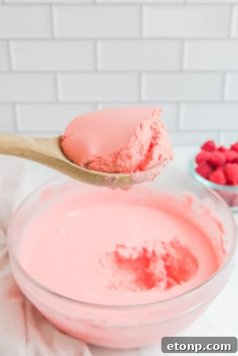 A close-up view of the ingredients mixing process for Jello Fluff.