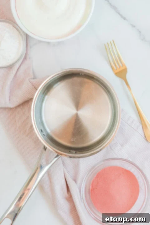A serving of Raspberry Jello Fluff in a small white bowl, garnished with whipped cream.