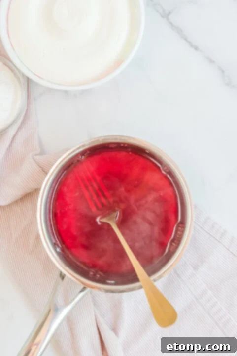 Close-up of the smooth, pink texture of Raspberry Jello Fluff.
